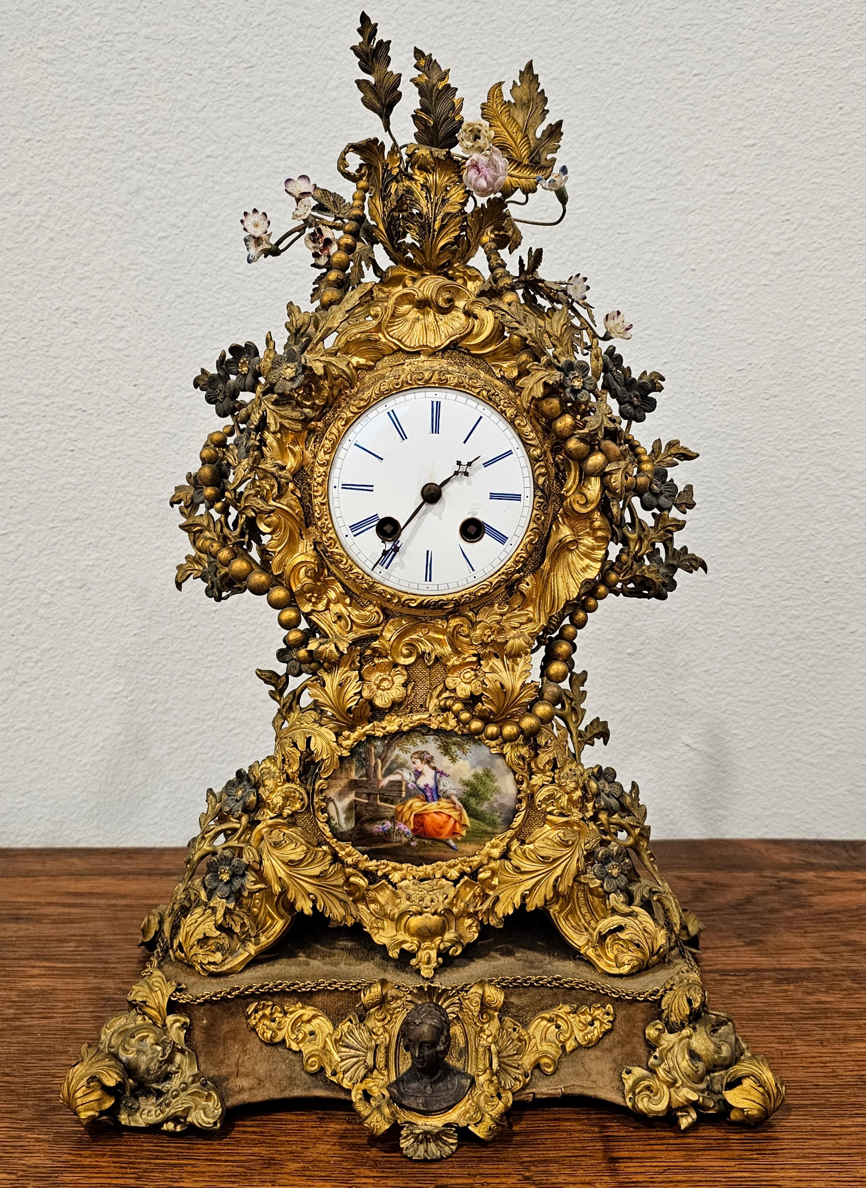 A breathtaking antique French Belle Époque period (1871-1914) porcelain mounted mixed metal mantel clock.

Born in France in the late 19th / early 20th century, fine quality Parisian work, exceptionally executed in luxuriously opulent 18th century