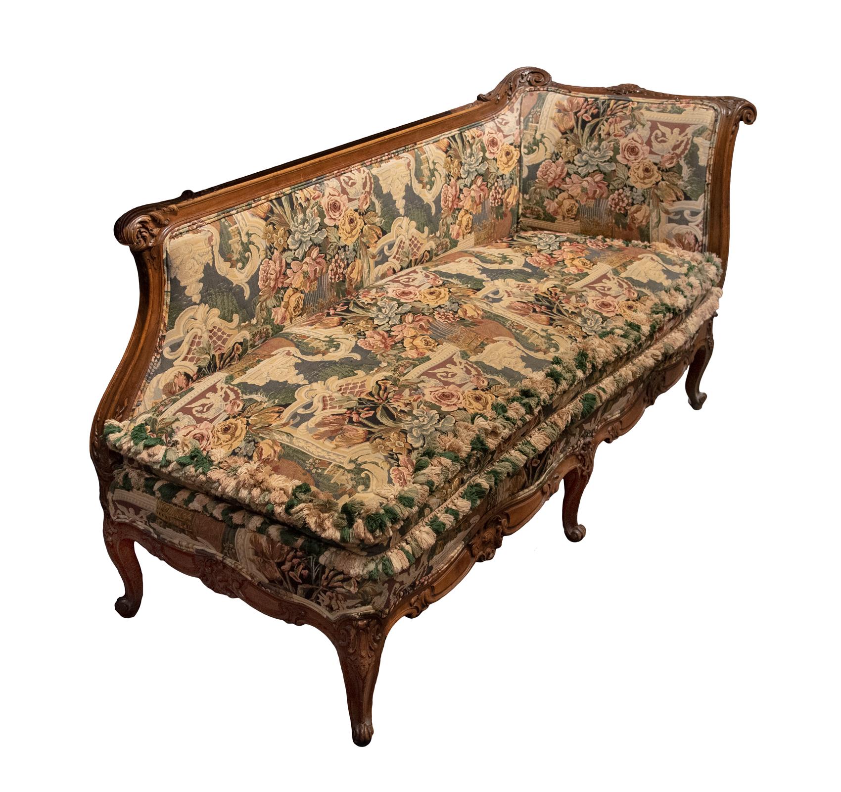 Crafted in France in the latter part of the 19th century in hand carved oak with floral and acanthus leaf motifs. Comfortably upholstered in an intricate floral tapestry material.

Measures: 36 H x 66 W x 26.5 D inches, 18.5 in. seat height.