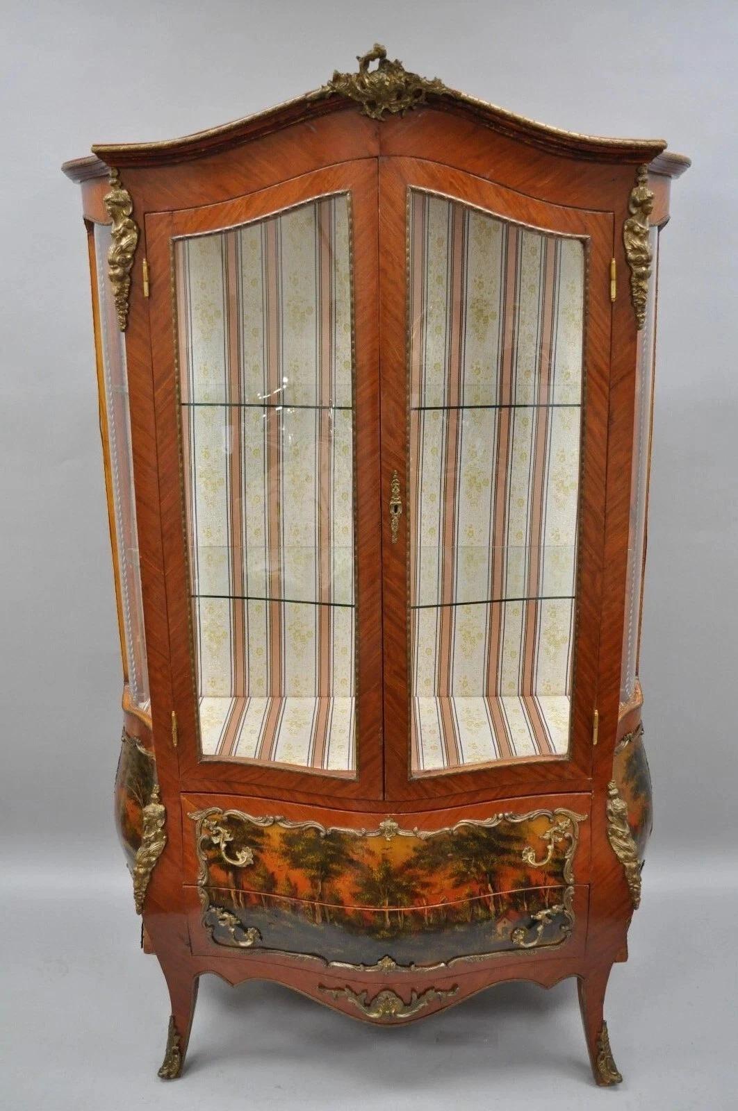 Vintage French Louis XV Style Reproduction Bombe Curio China Cabinet Vitrine with Bronze Ormolu. Item features upholstered interior, bombe form, 4 curved glass exterior panels, painted scenes, 2 shaped glass shelves, very impressive appearance.