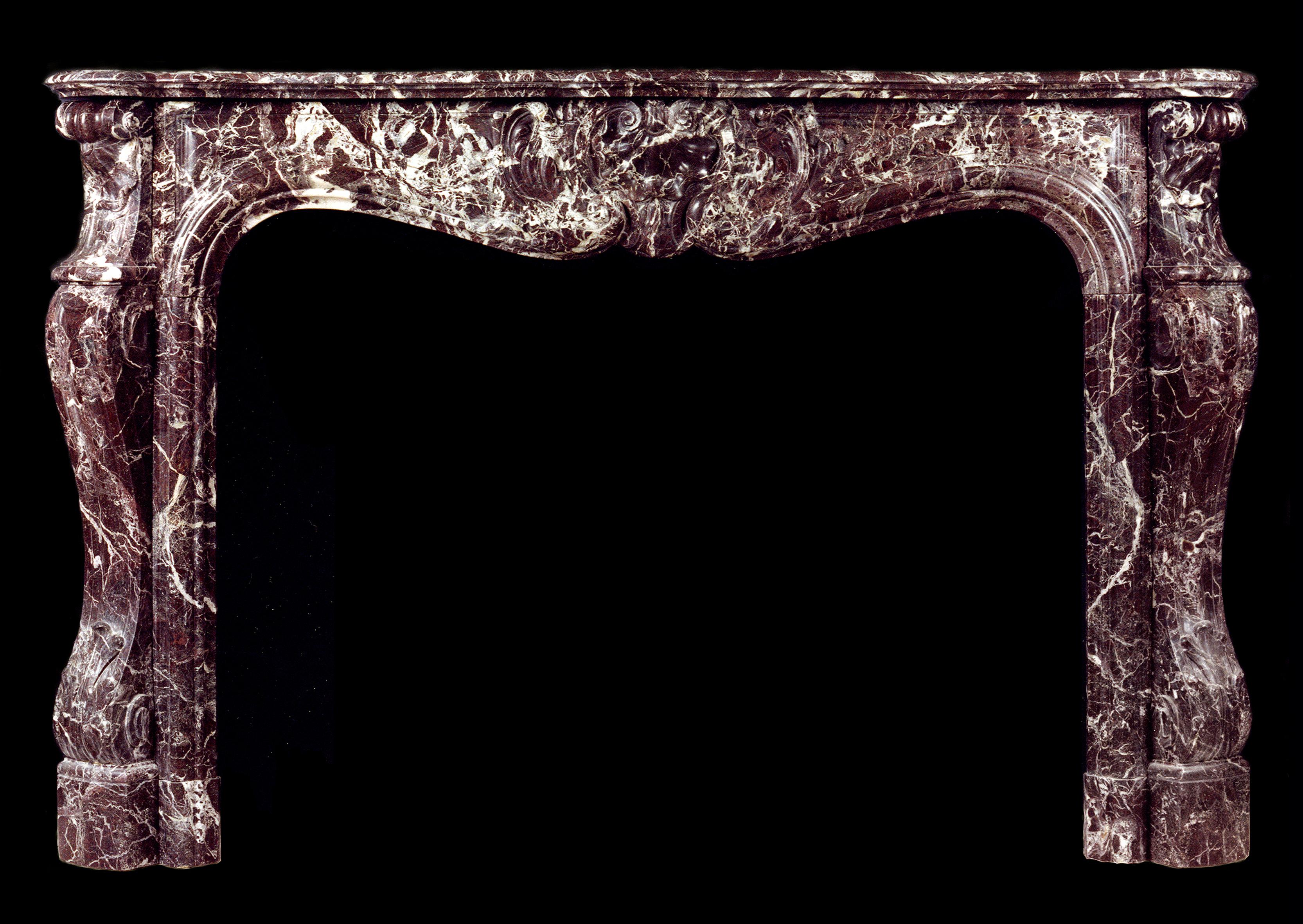 A French Louis XV style Rosso Levanto marble fireplace with carved shells to centre of frieze and end blockings, shaped moulded jambs with carved leaves. An elegant, dark red marble with white veining, 19th century.

Shelf Width:	1725 mm      	67