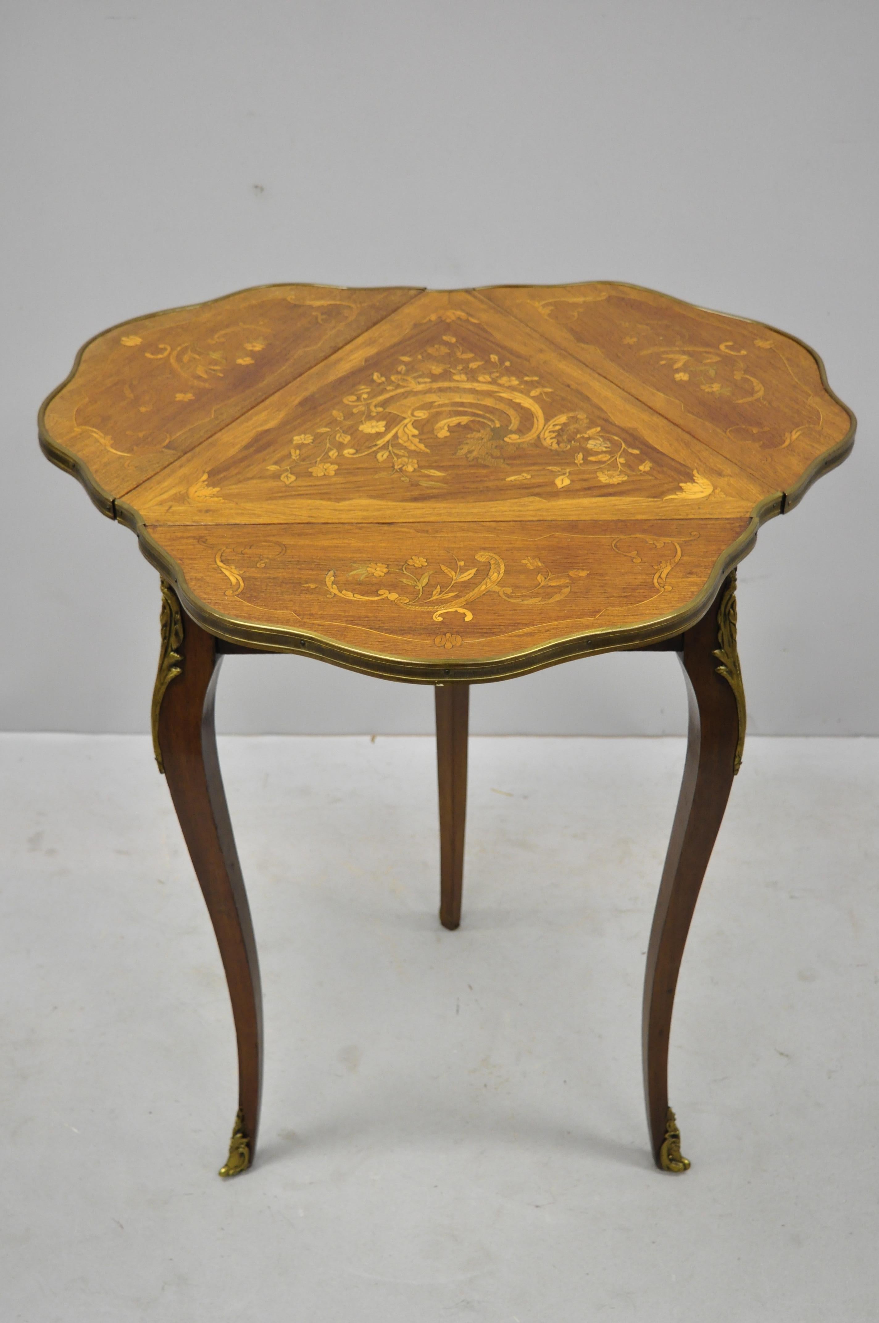 French Louis XV style satinwood inlay drop-leaf side table with bronze ormolu. Item features floral satinwood inlay, bronze ormolu three drop sides, cabriole legs, quality French craftsmanship, stamped 