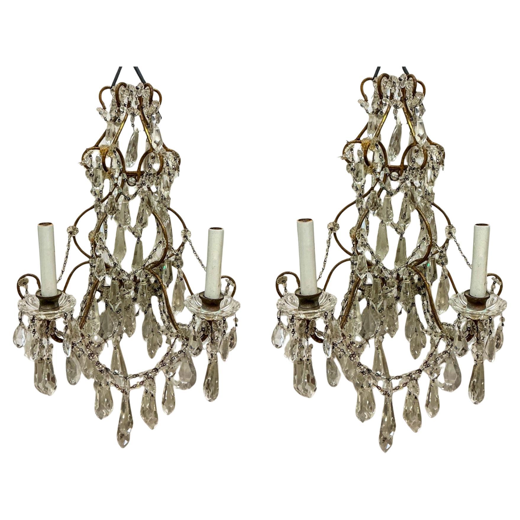 This is a pair of cut glass sconces that are dripping with cut glass prims! It is a dual candelabra with bronze frame. The hand applied macaroni beads just add the right touch of beauty to enhance their shimmer. They date to the 40s. The wiring is