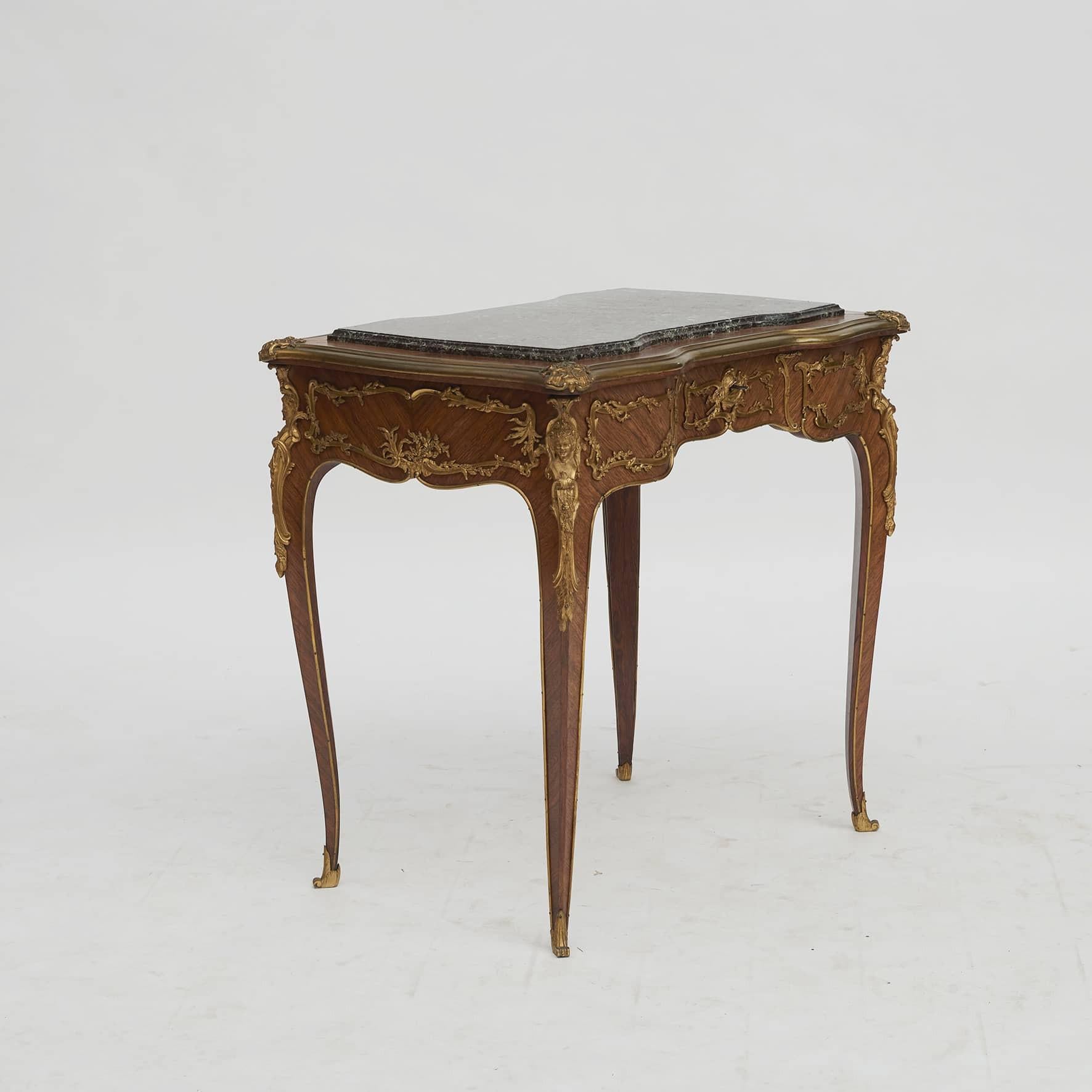 French side table crafted from gilt bronze mounted Kingswood.
Slightly raised top in Rosso Levanto marble in shades of red, green and grey.
France c. 1890.
This exquisite quality side table is attributed to the important furniture maker