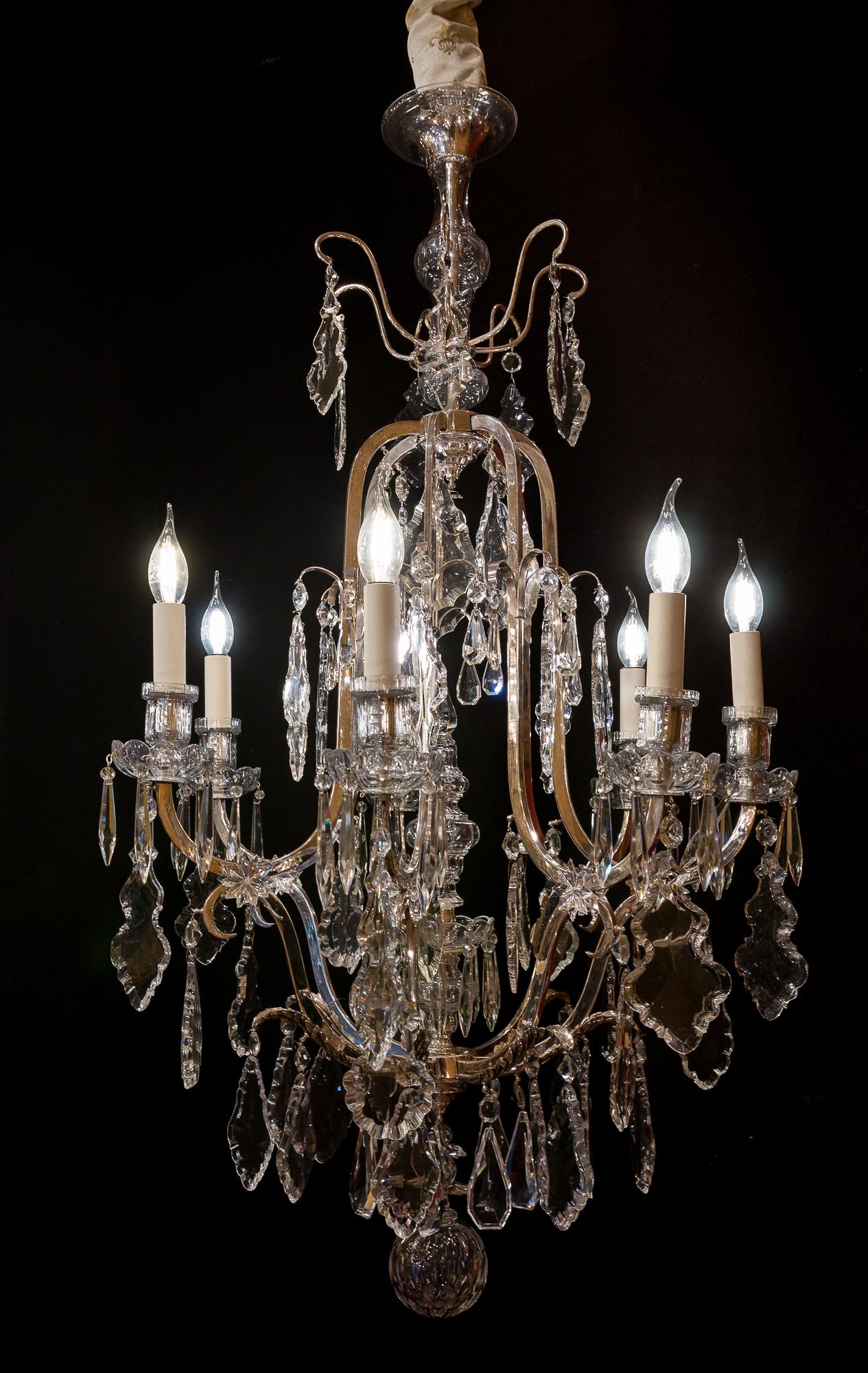 French Louis XV style, silver-plate and cut-crystal chandelier, circa 1920-1950.

Lovely silver-plate and cut crystal chandelier in the classic French Louis XV style.
Our chandelier is composed of seven perimeter arm-lights.
Excellent quality