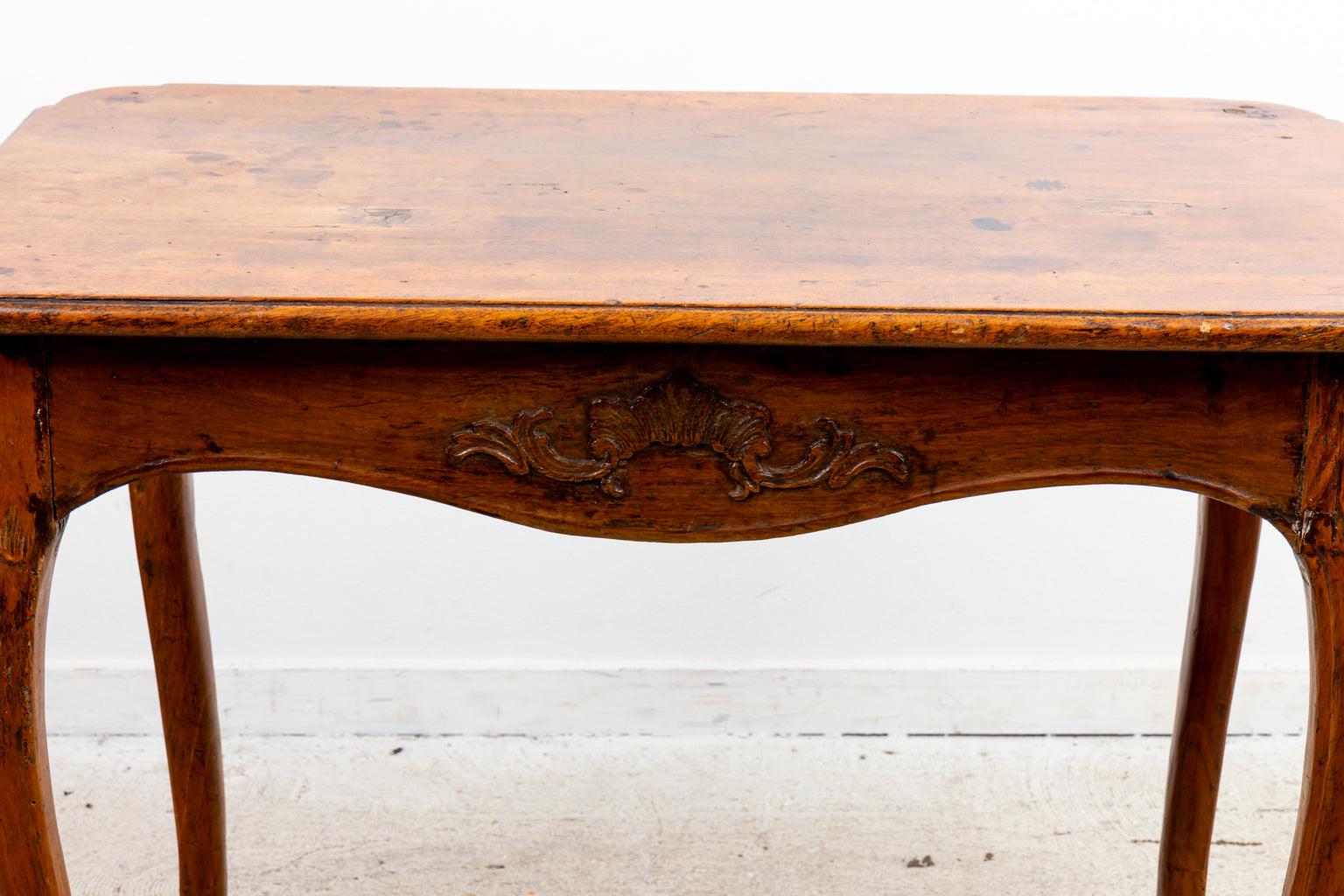 Early 19th Century Louis XV style table with shaped carved corners, resting on shaped cabriole legs, one board top.
