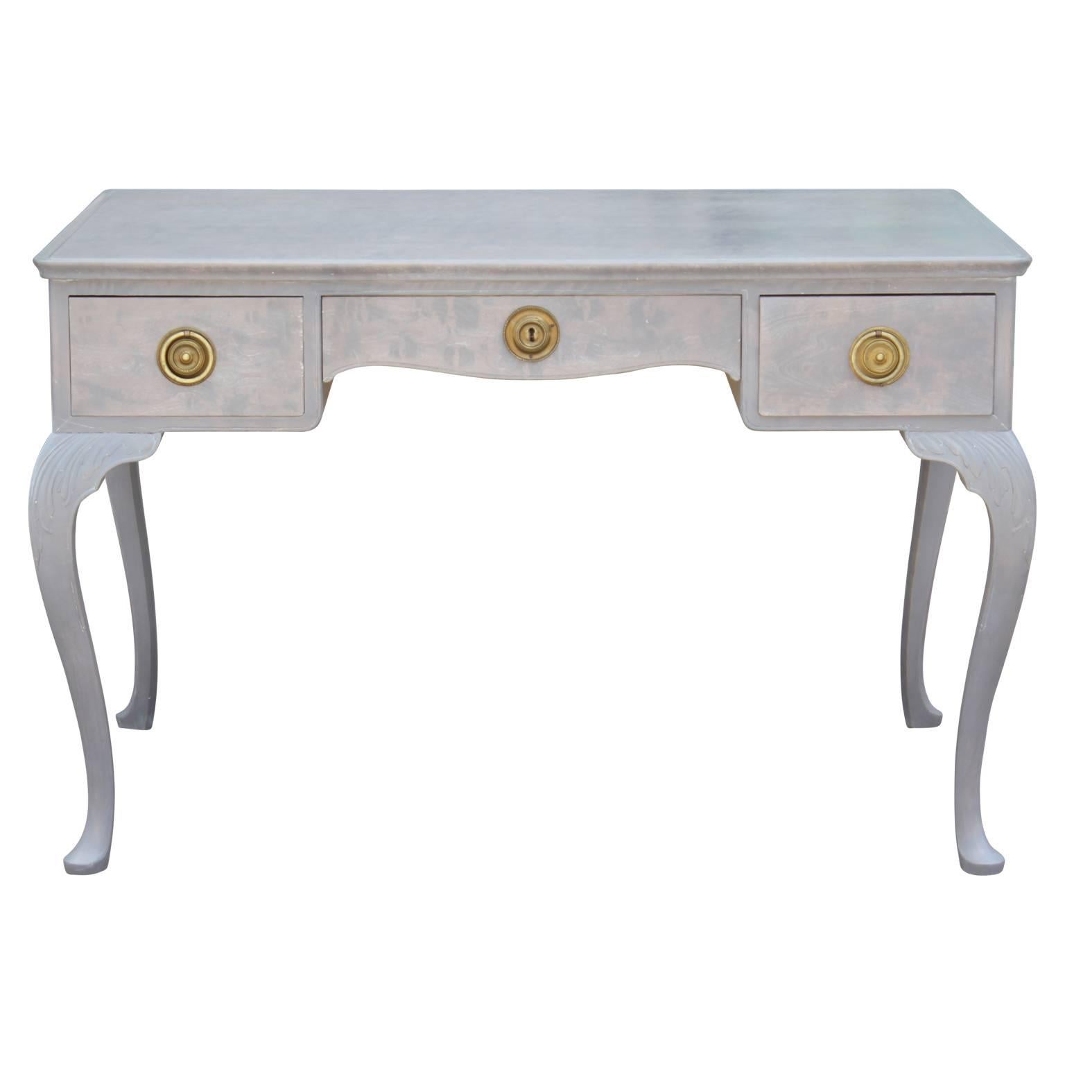 Gorgeous and unique French Louis XV style grey desk with brass hardware. Features three drawers; left, right and center perfect for all storage needs! In nice vintage condition. No major flaws.