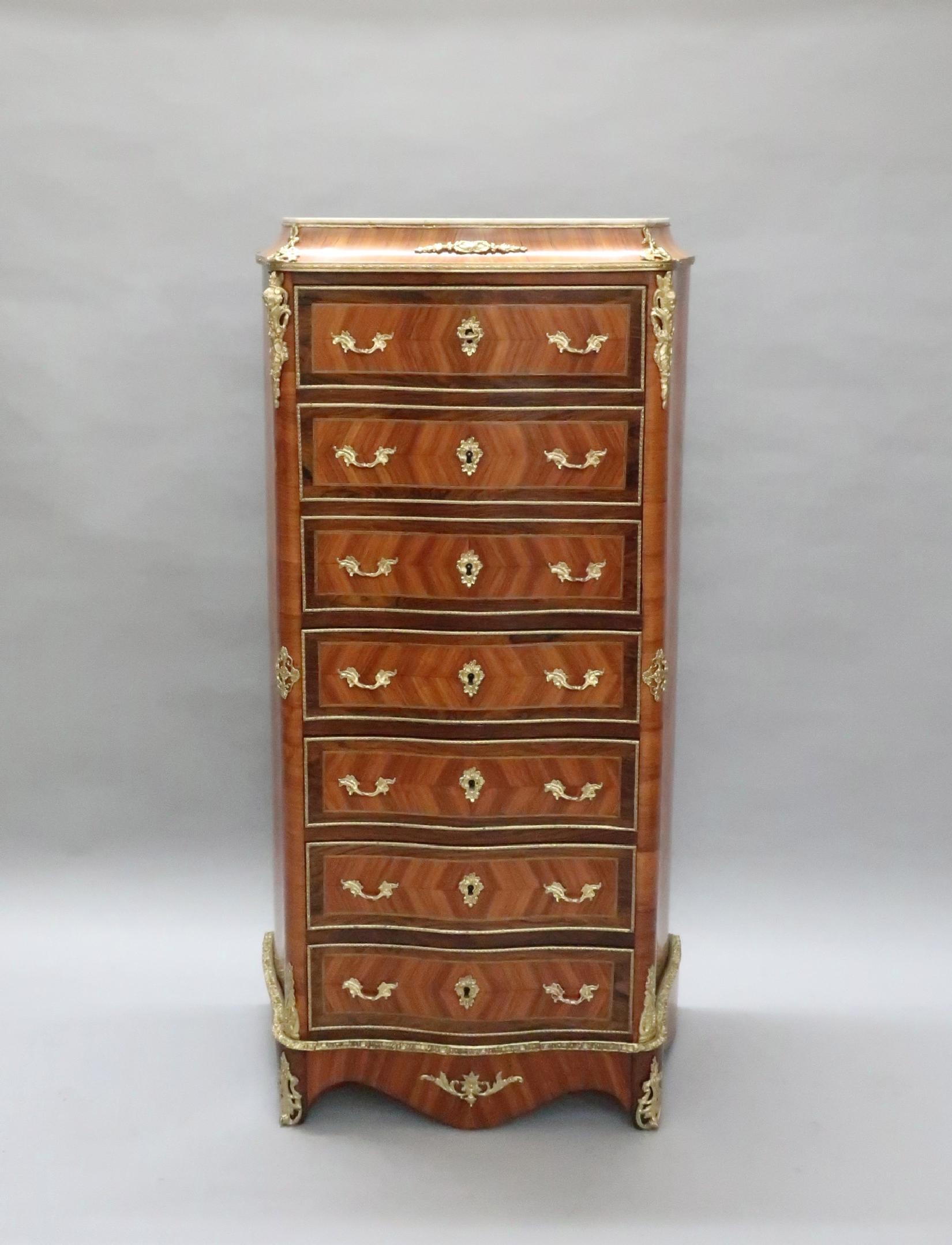 An extremely good quality French Louis XV style quarter veneered feather banded tulip wood and king wood banded serpentine shaped escritoire writing cabinet still retaining its original white Carrara marble-top. The cabinet has bronze gilt ormolu