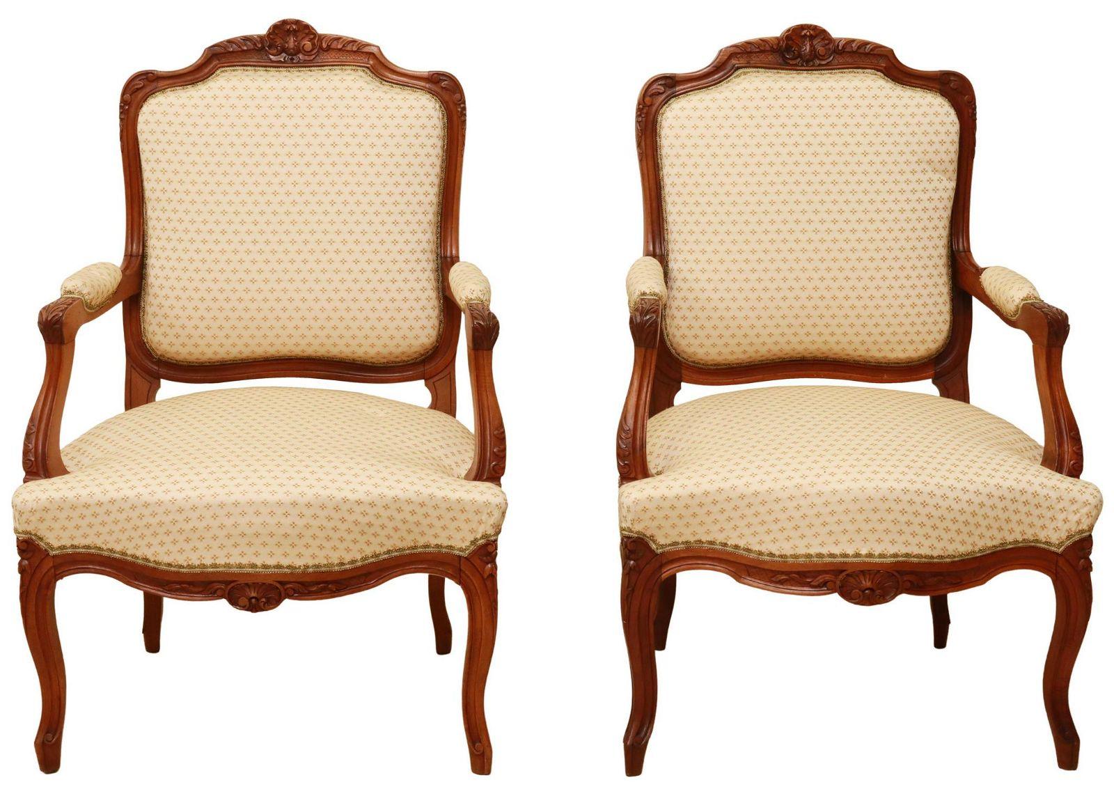 French Louis XV style armchairs, 20th c., having carved rocaille crest, in a floral upholstery, with foliate handholds, above shell motif apron, rising on cabriole legs, ending on whorl feet.

Dimensions
approx 37.5