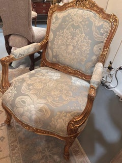 French Louis XV style walnut and parcel gilt arm chair