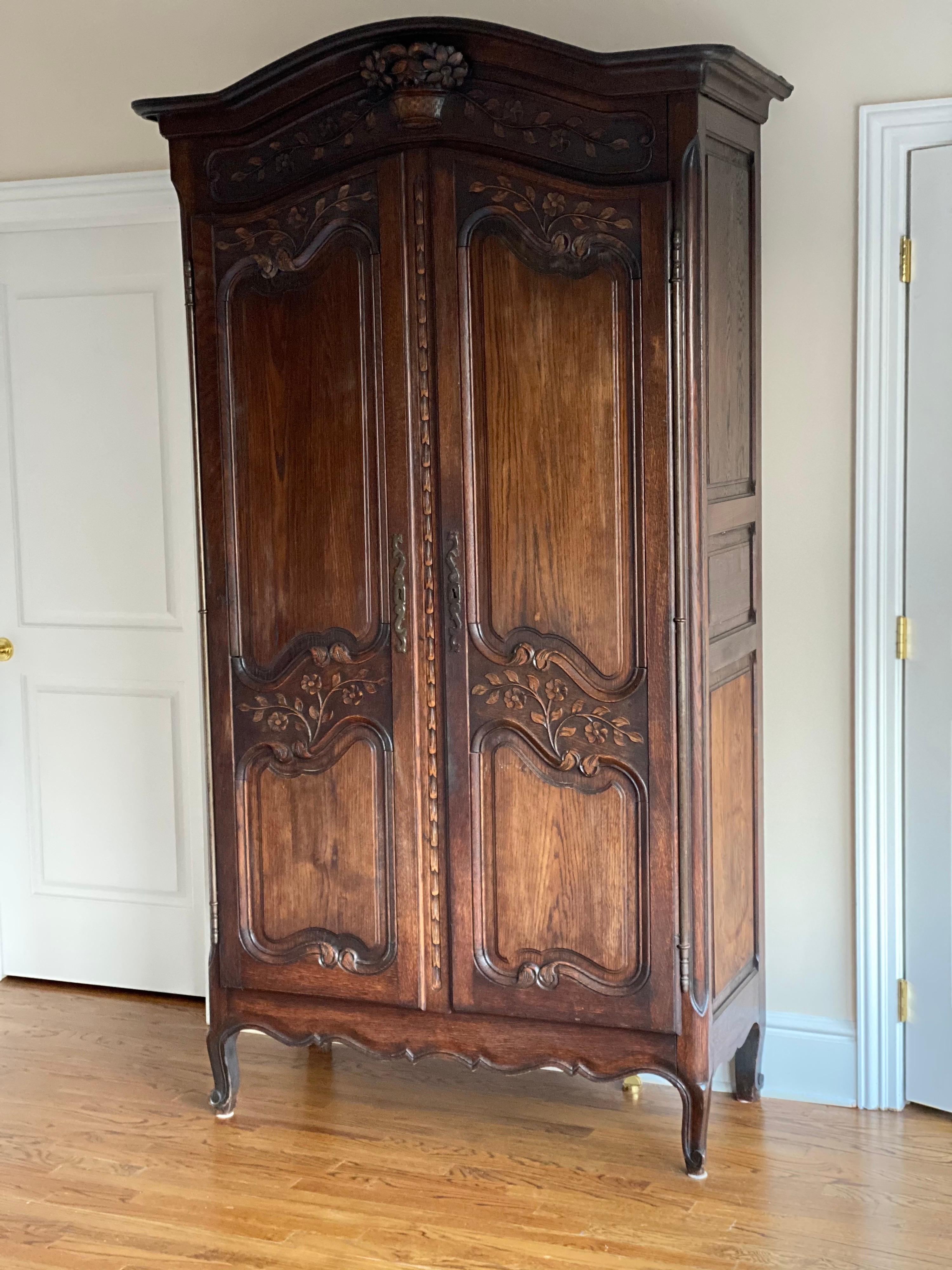 French Louis XV style walnut armoire
This armoire is more slender than the Classic Louis XV armoires. The carving is nicely done and a really lovely scale. Foliage, scrolling, and bouquet are nicely carved. Two doors open to four shelves (some