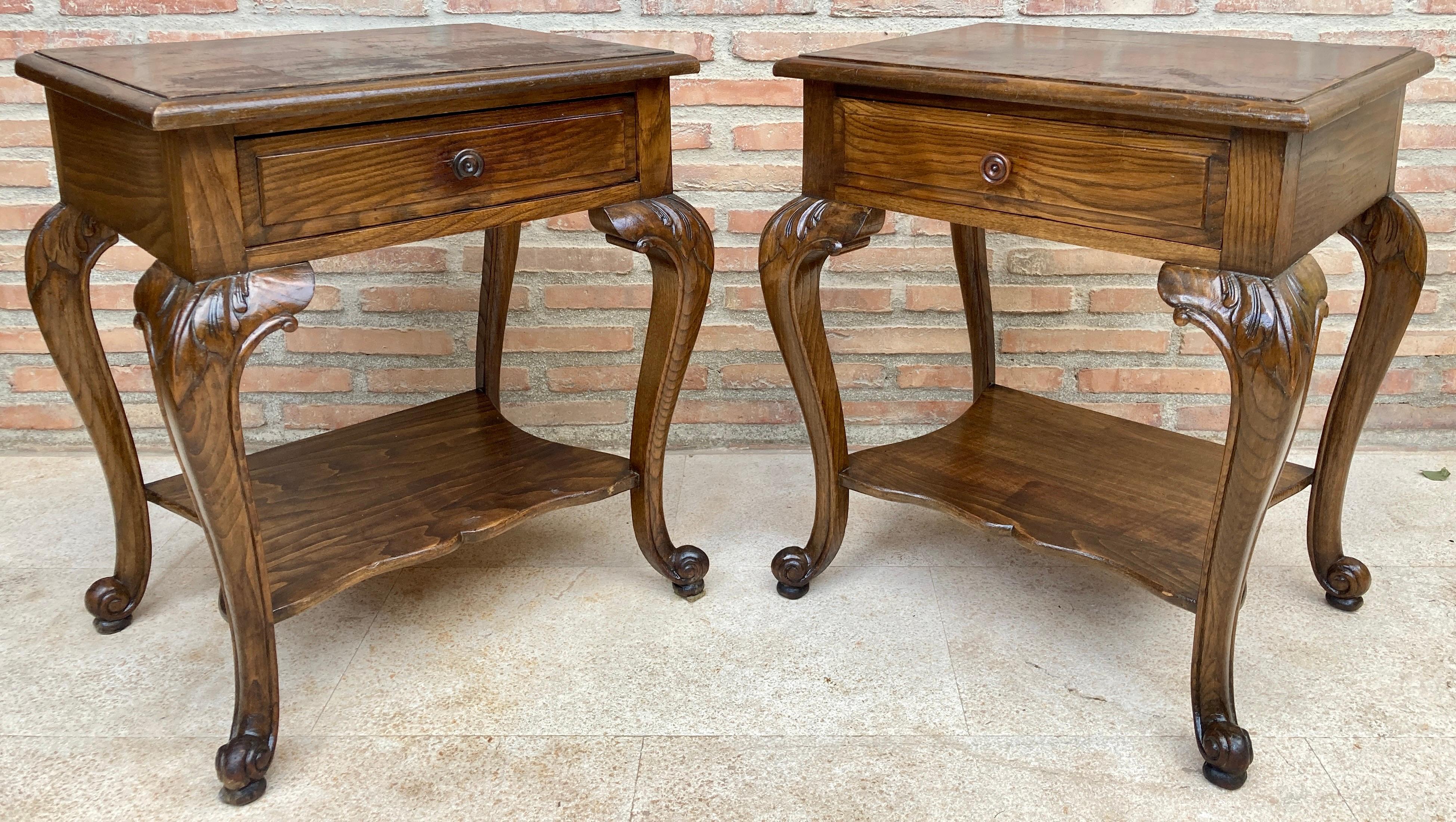 Early 20th century walnut nightstands with one drawer, set of two. 
Pair of early 20th century Louis XV style French walnut bedside tables. This pair of French 'tables de chevet' was created in the early years of the 20th century, at a time when