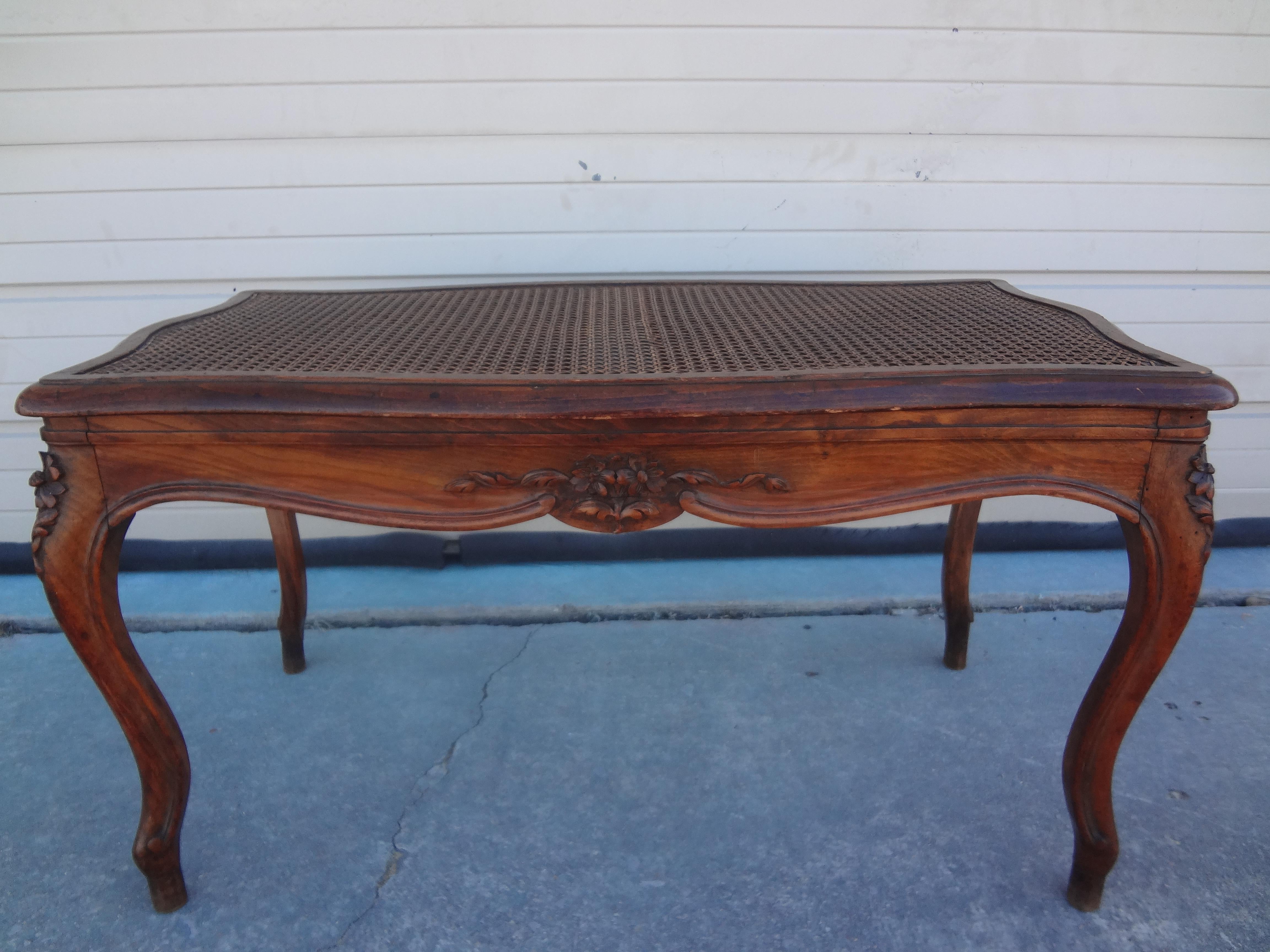 French Louis XV style walnut cane bench. This stunning French bench is a light shade of walnut and the cane seat is in very good tight condition. Our versatile French bench would work well in an entrance hall, living area, bedroom or dressing area.