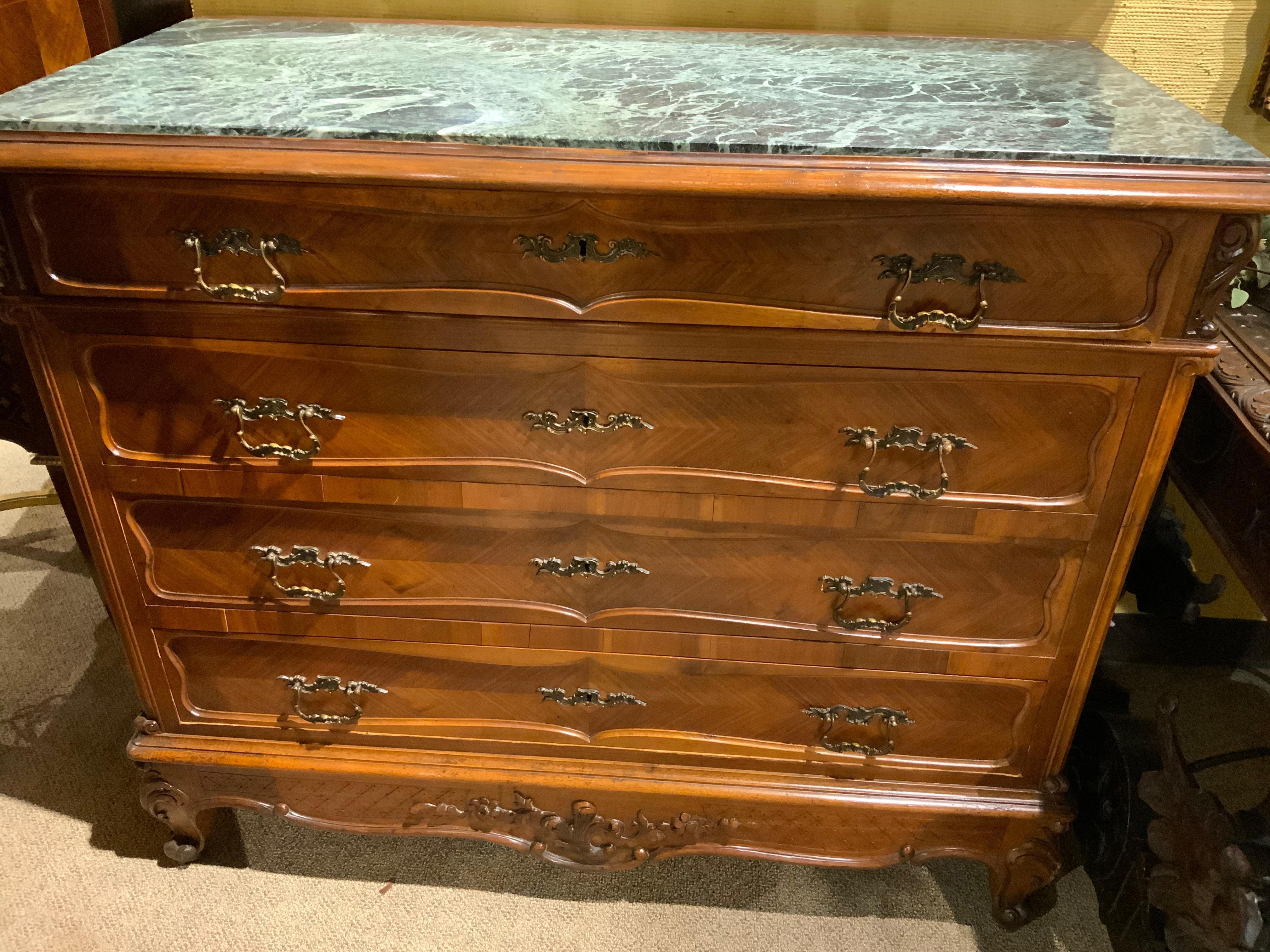 Antique French walnut Louis XV style chest of drawers with four drawers 
That are great for storage having a verde marble top with mingled shades 
Of green with light veins of white. Original bronze hardware, and a carved
Scroll cabriole leg.