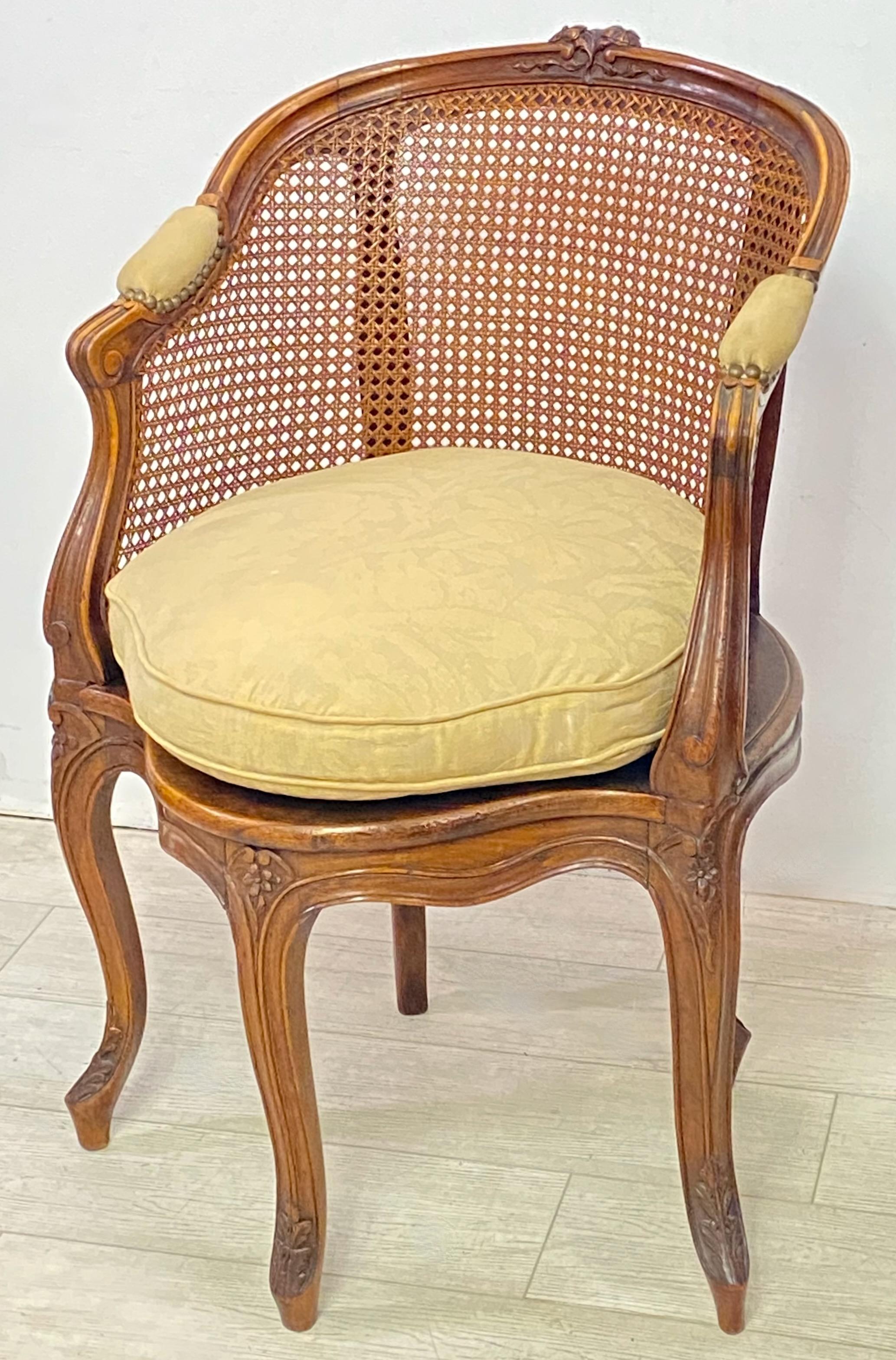 Traditional Louis XV style fauteuil de bureau desk chair for a study. Carved walnut frame with carved floral decoration standing on five elegant cabriolet legs. 
This timeless armchair is in very good condition commensurate with age and use, and