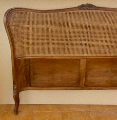 French Louis XV Style Walnut Headboard with Cane Panel and Carved Details