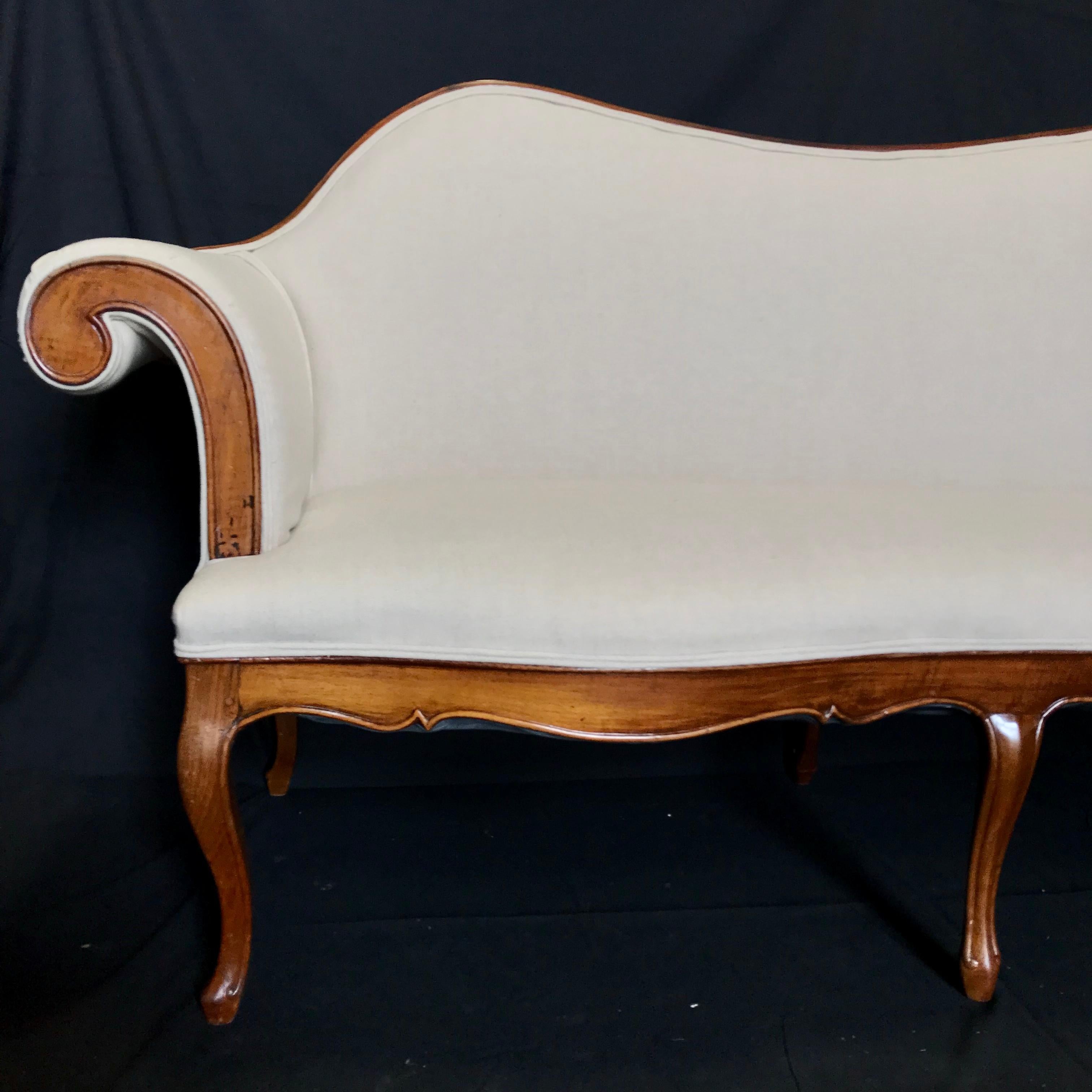 A sleek glamorous Louis XV style 19th century walnut loveseat having Beidermeieresque curved arms and fresh new French cotton linen upholstery. 
#5747
Measures