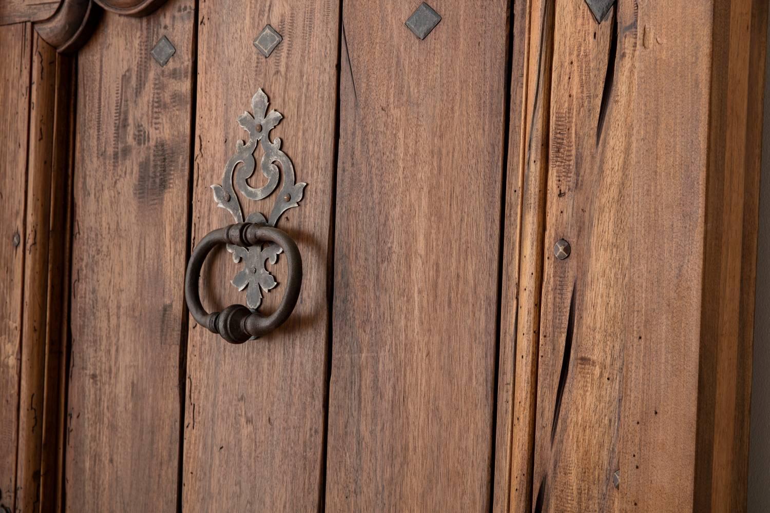 A newly constructed French Louis XV style walnut entry door made by Provençal artisans using traditional methods. This door features iron hardware and detailing typical of the Provençal style. Keys included.  The measurements provided are for the