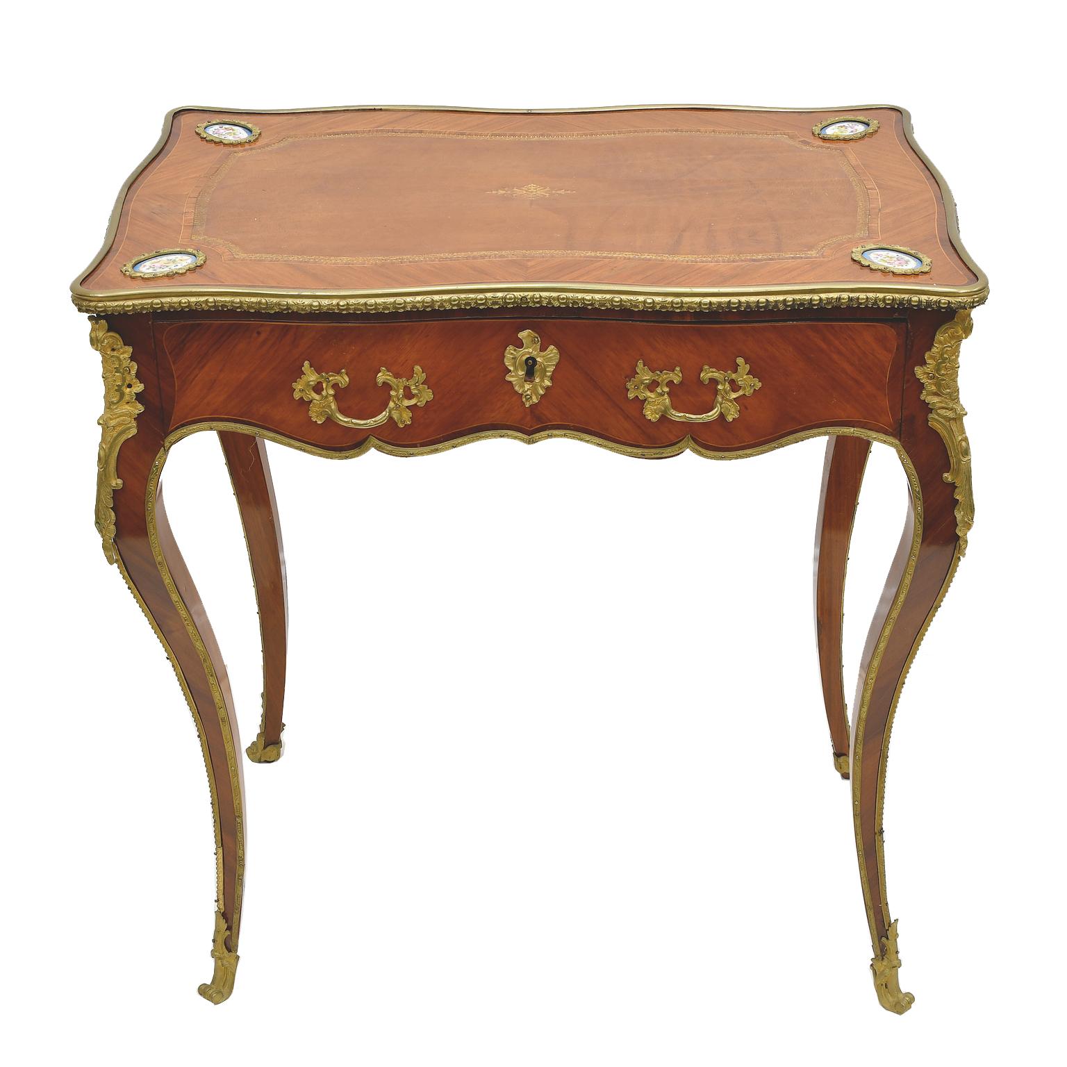 A lovely 19th century French Louis XV style salon table with serpentine form on all sides, slim cabriole legs and one-drawer. This Belle Époque table which likely served various duties, as a writing table, tea and games table, features bronze d'ore