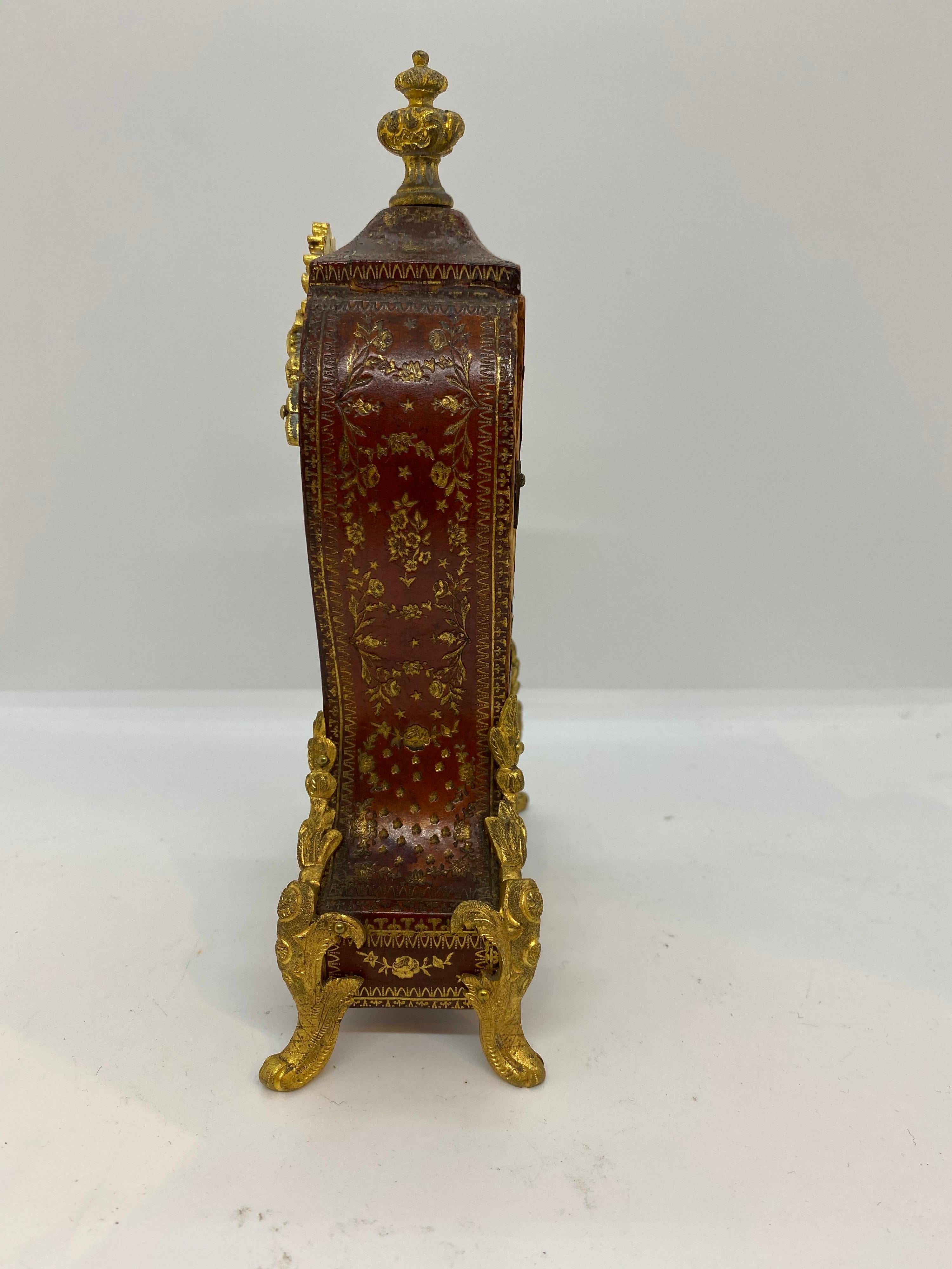 French gilt bronze mounted tooled leather table clock inscribed on enamel face
Classes-Lunardi 1 rue de Choissul Paris.

 