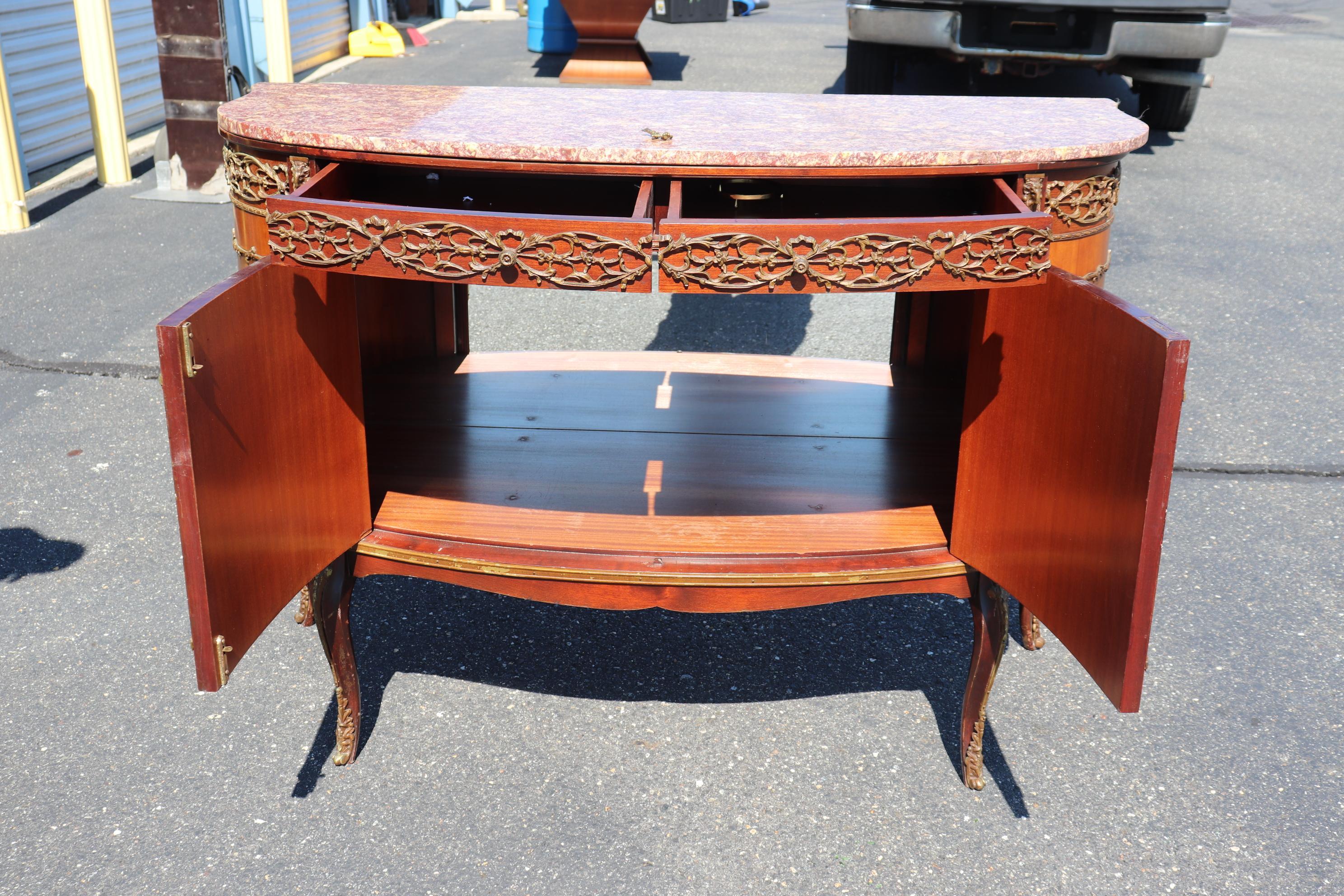 This is a beautiful French commode that was professionally convertedinto a bar with a mirrored back inside and lighting to display your favorite liquors and aperitifs. The commode features a beautiful slab of French marble and scenery painted on top