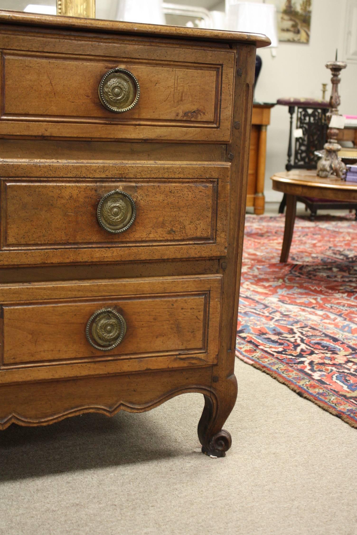 Exceptional Louis XV walnut commode with three drawers and beautiful carved details and patina.