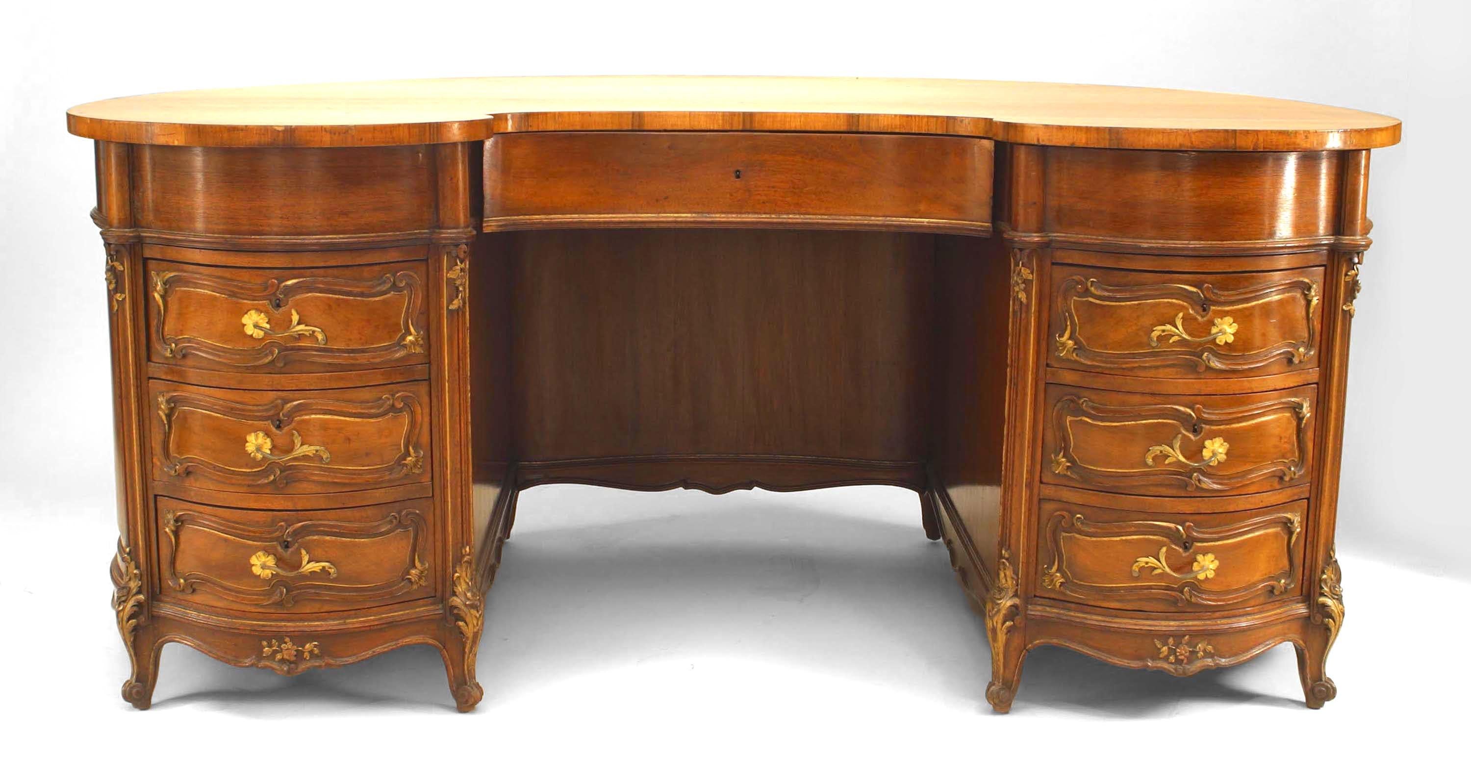 19th century French Louis XV style walnut kidney shaped kneehole desk with gilt trim and brass scroll handles.
