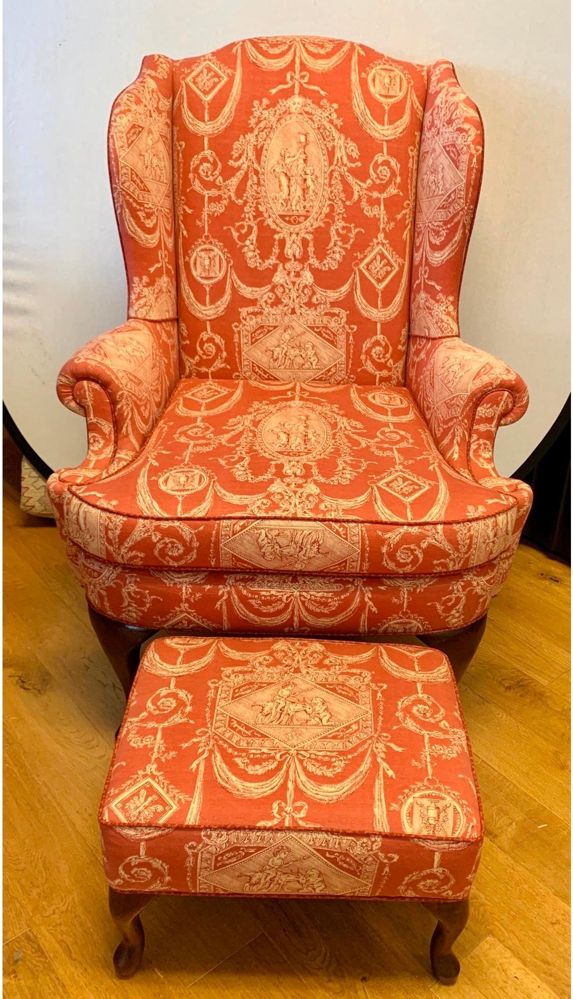 Stunning red Toile fabric surrounds this French wingback chair. The cotton blend fabric is fairly recent and in great condition. The chair dates to the 1950's.