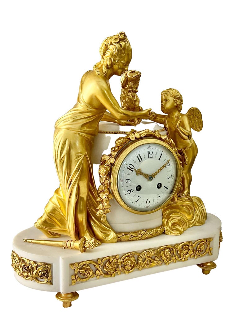 A wonderful French Louis XV1 style striking figural ormolu-mounted white marble clock. 

The beautifully cast figures of Venus and Cupid are springing from clouds, with burning torcher at their feet and a dog between them symbolising eternal love