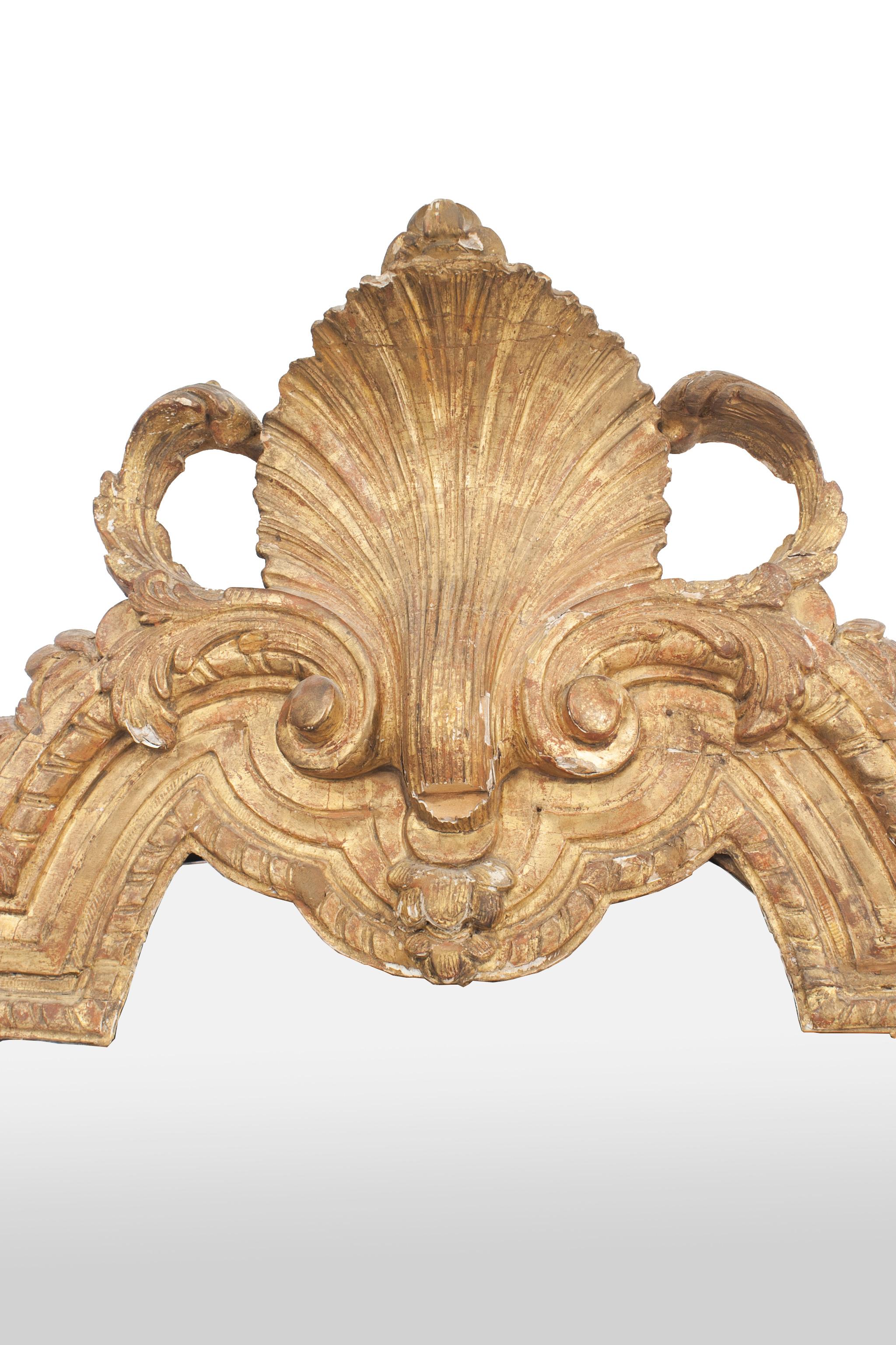 French Louis XVI '18th Century' carved gilt wall mirror with shell pediment and filigree detail in corners.
 