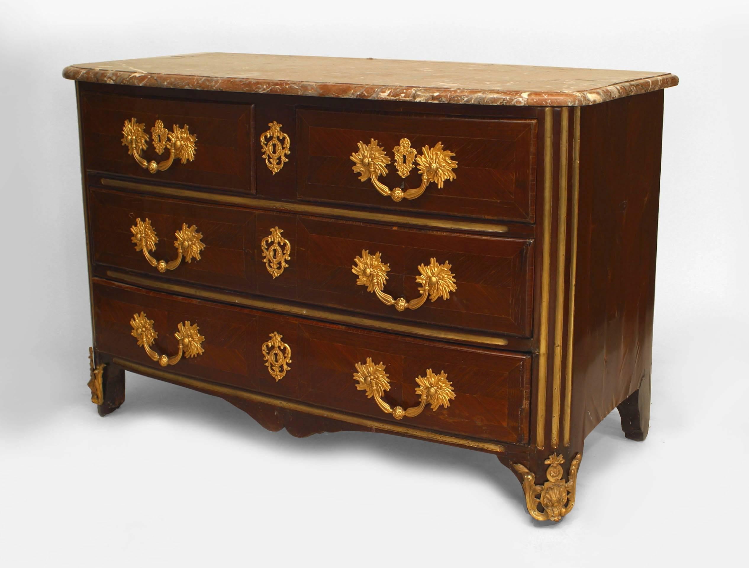 French Louis XVI (18th Century) mahogany veneered chest with 2 large drawers under a Pair of drawers embellished with bronze mounts & brass fluted trim with a brown marble top.
