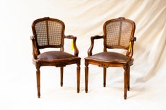 French Louis XVI Armchair with Cane back and Leather Seat & Armrest, a pair