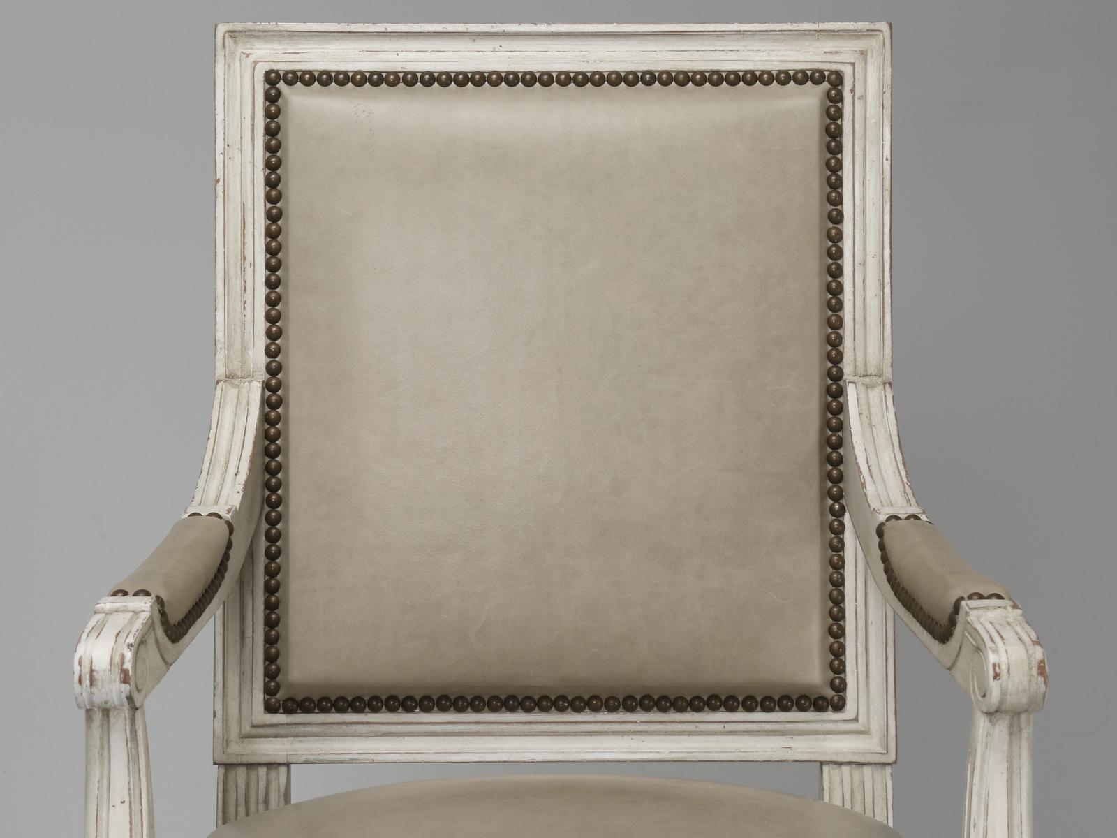 Louis XVI style Armchairs Hand-Made in France in a distressed Old Plank crème white lacquer and upholstered in a leather with a smooth grain; other colors available upon request. We have these authentic style Louis XVI Armchairs and matching Louis