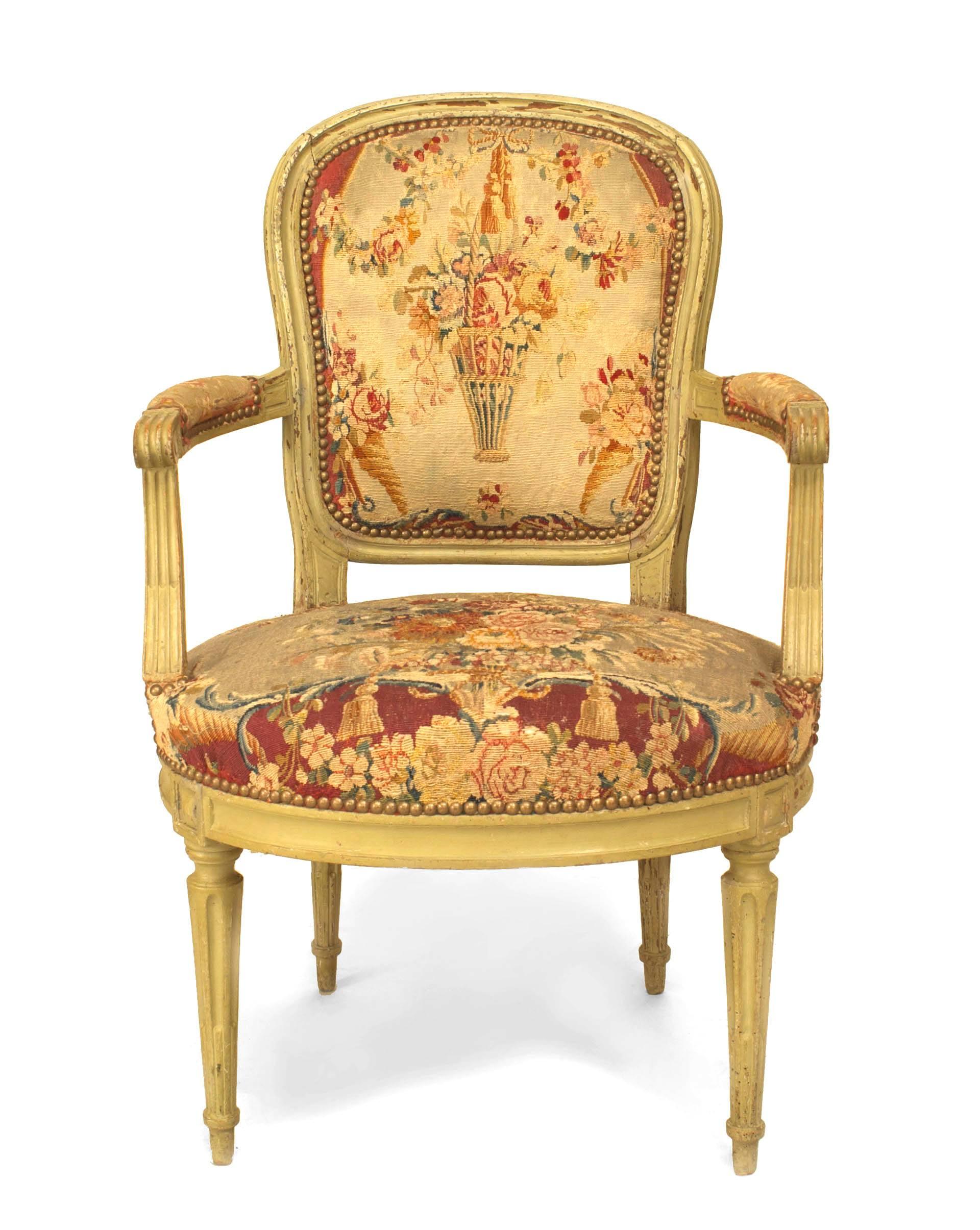 Set of 6 Louis XVI (circa 1795) grey painted open arm chairs with original floral design tapestry upholstered seat and back. (Stamped: F. Lapierre a Lyon)
