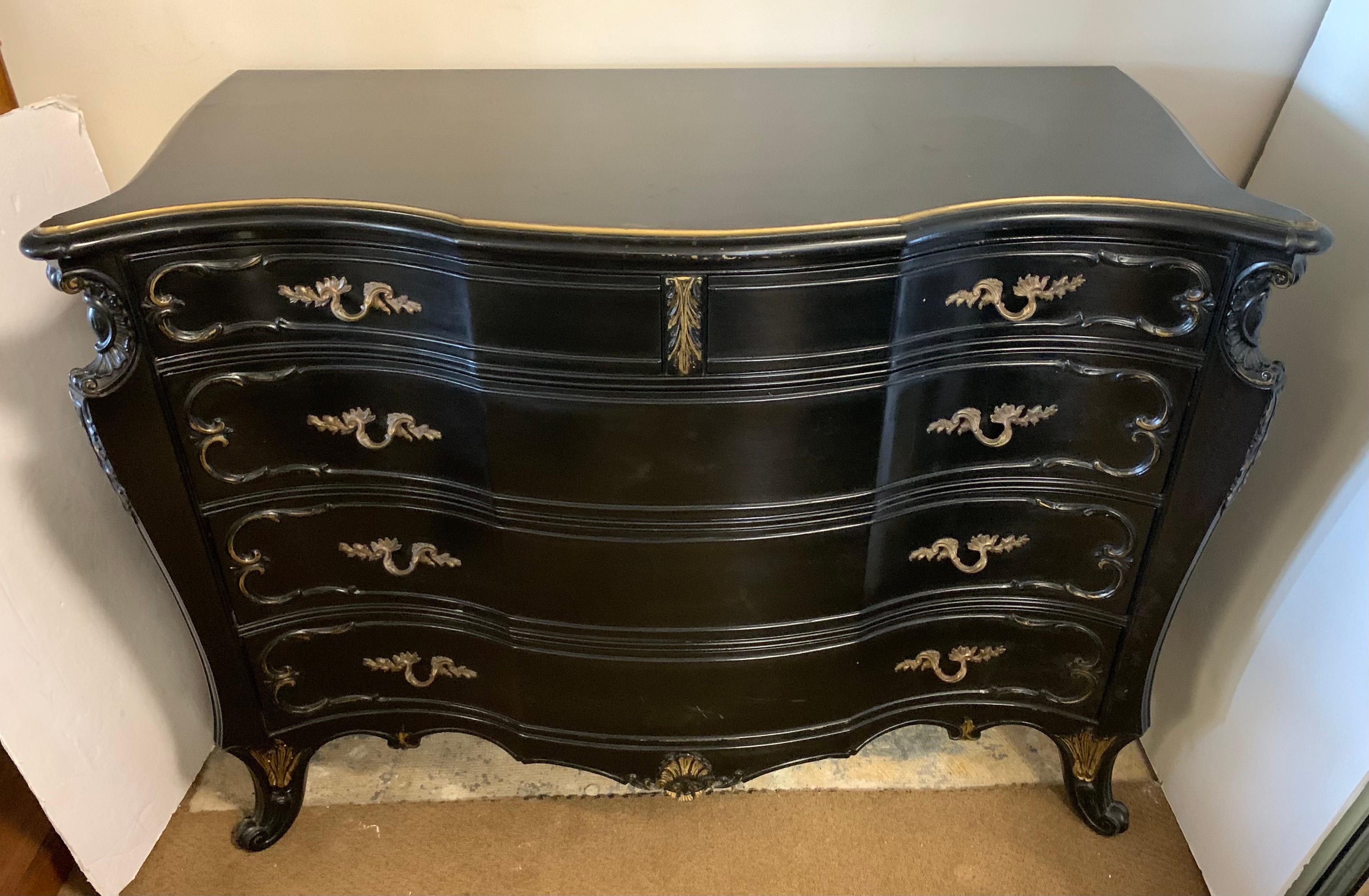 This fine quality vintage French style dresser has been refreshed with black paint and gold accents. It has four dovetailed drawers. Would look great in a foyer or bedroom.
 