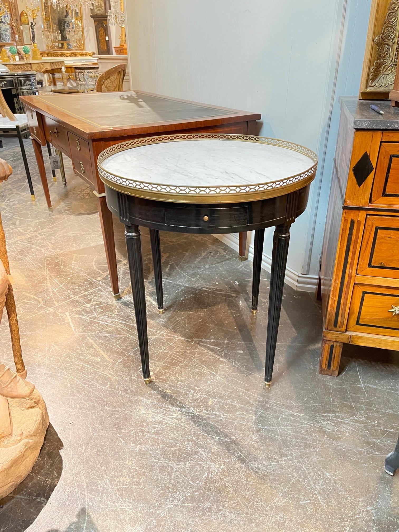 Gorgeous French Louis XVI Jansen style black lacquered table with marble top and brass galleries. A Classic piece for a fine home!