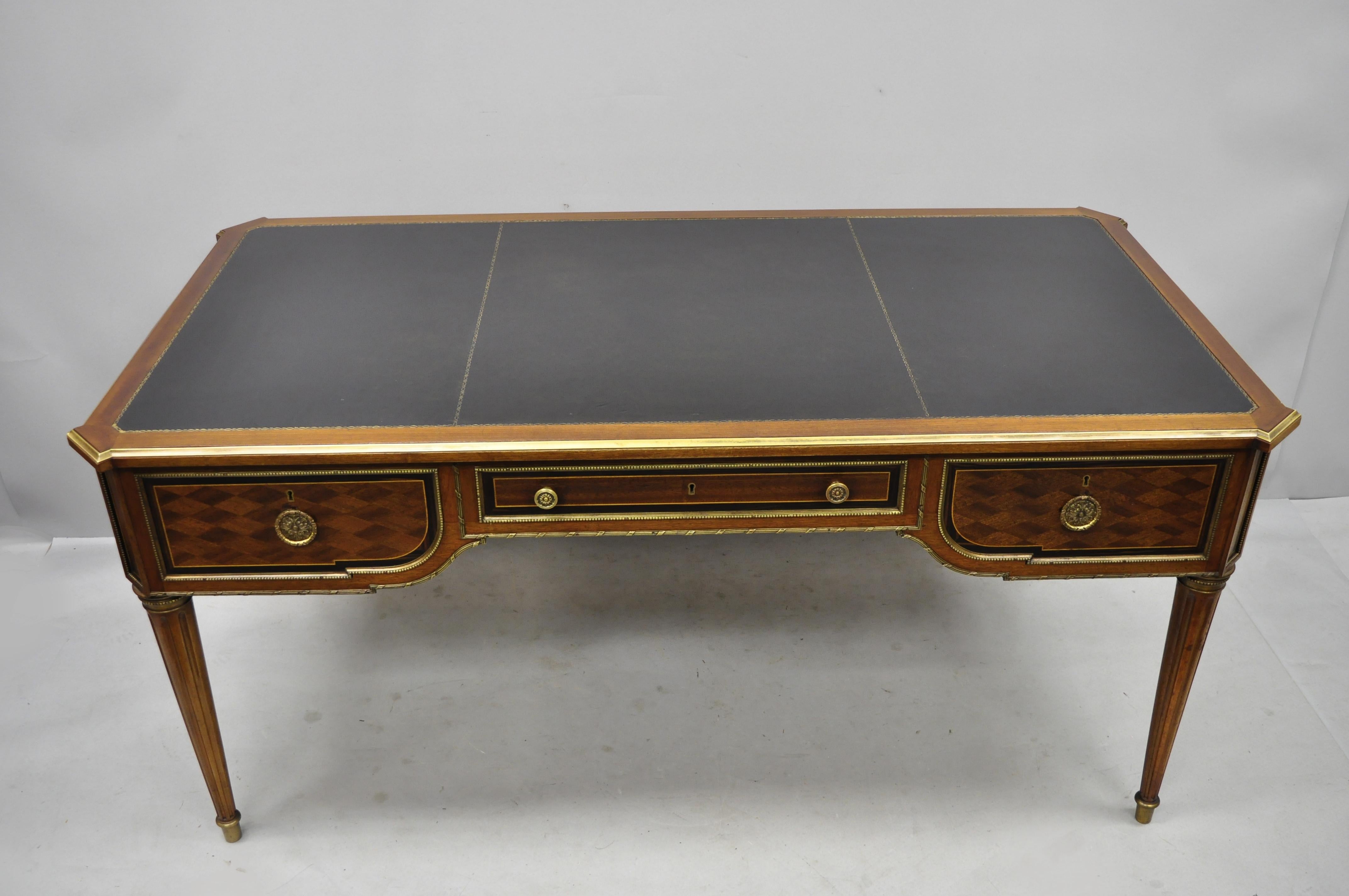 French Louis Style XVI black leather top bureau plat desk by Simon Loscertales Bona. Item features black tooled leather top, bronze ormolu, bronze edge, beautiful wood grain, finished back, original label, 3 dovetailed drawers, tapered legs, nice