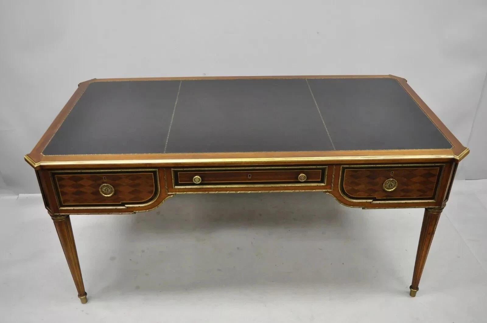 Vintage French Louis XVI Style Black Leather Top Bureau Plat Desk by Simón Loscertales Bona. Item features a black tooled leather top, bronze ormolu, bronze edge, beautiful wood grain, finished back, original label, 3 dovetailed drawers, tapered