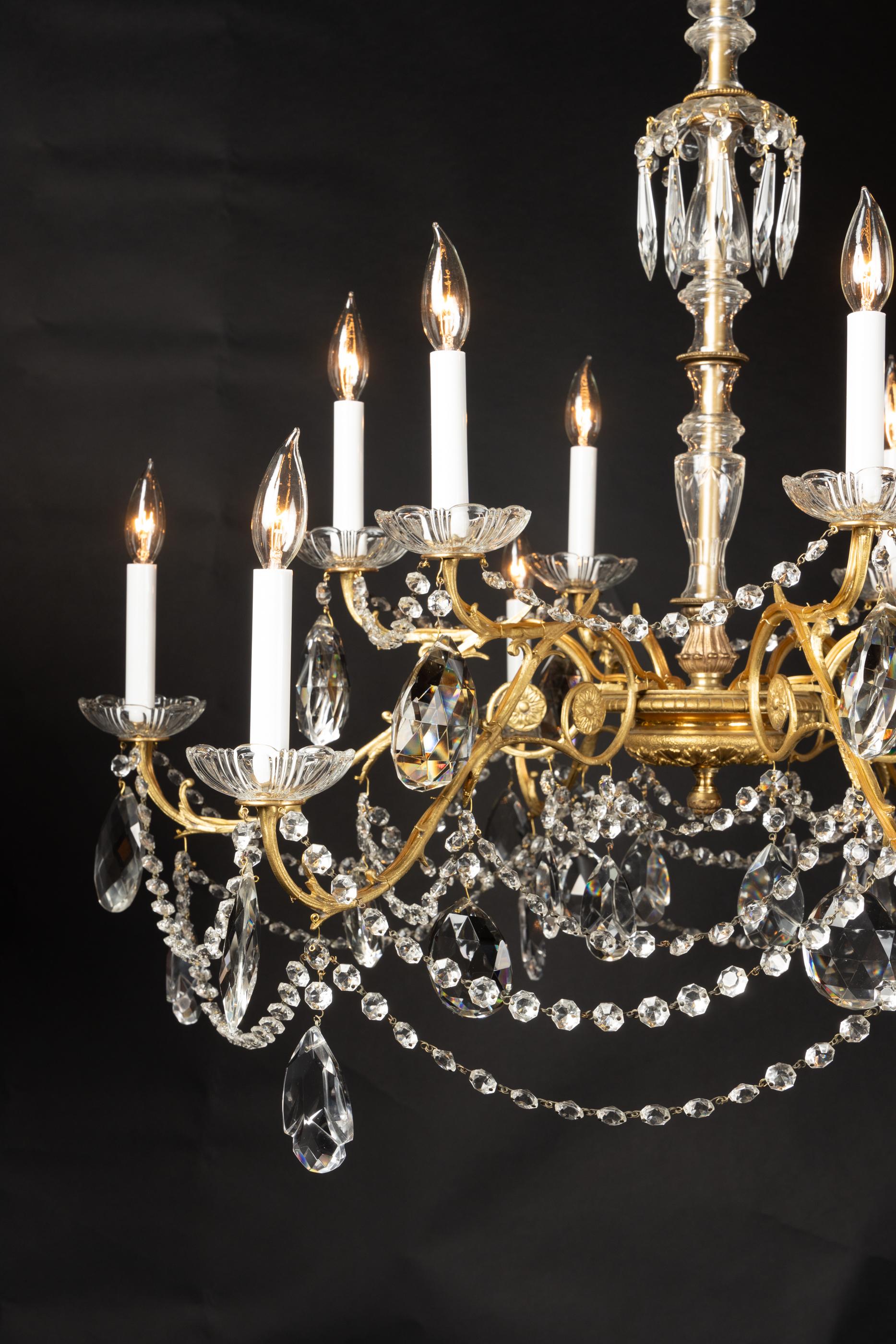 This classic Louis XVI chandelier dates back to the 19th century and features beautiful crystal surrounding the center stem. Ropes of octagonal crystal flows from the long bronze arms to give the chandelier beautiful negative space. This, combined