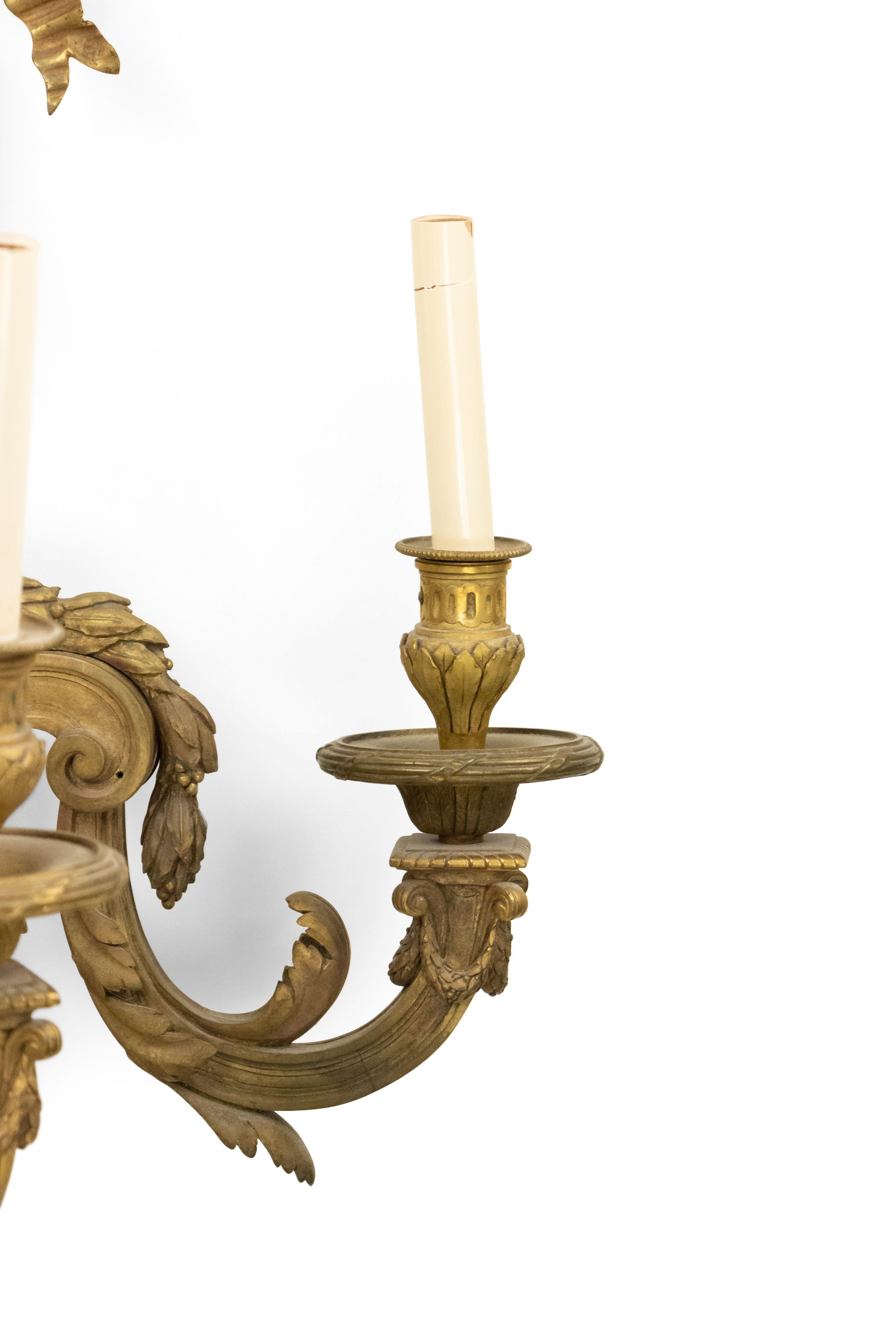 French Louis XVI-style (19th Century) bronze dore wall sconce with three scroll arms, bow knot top, and festoon design. (signed: G VIAM).
  