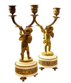 French Louis XVI Bronze Doré Candlesticks With Cherubs On Marble Plinths