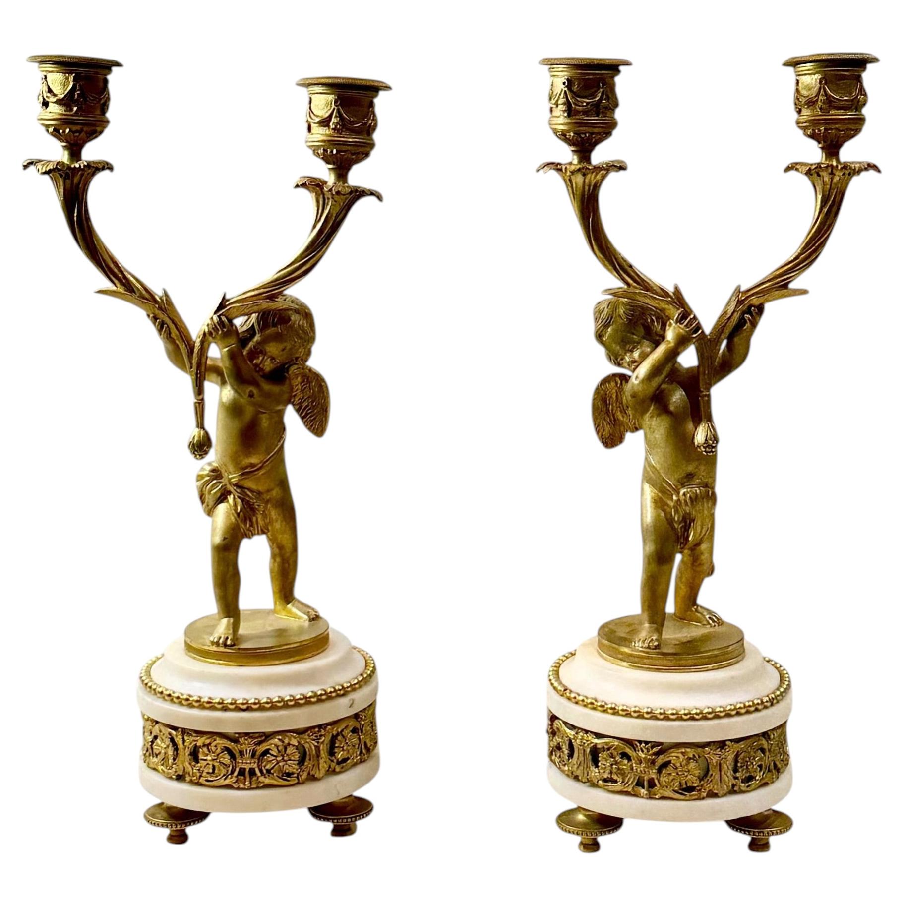 French Louis XVI Bronze Doré Candlesticks With Cherubs On Marble Plinths
