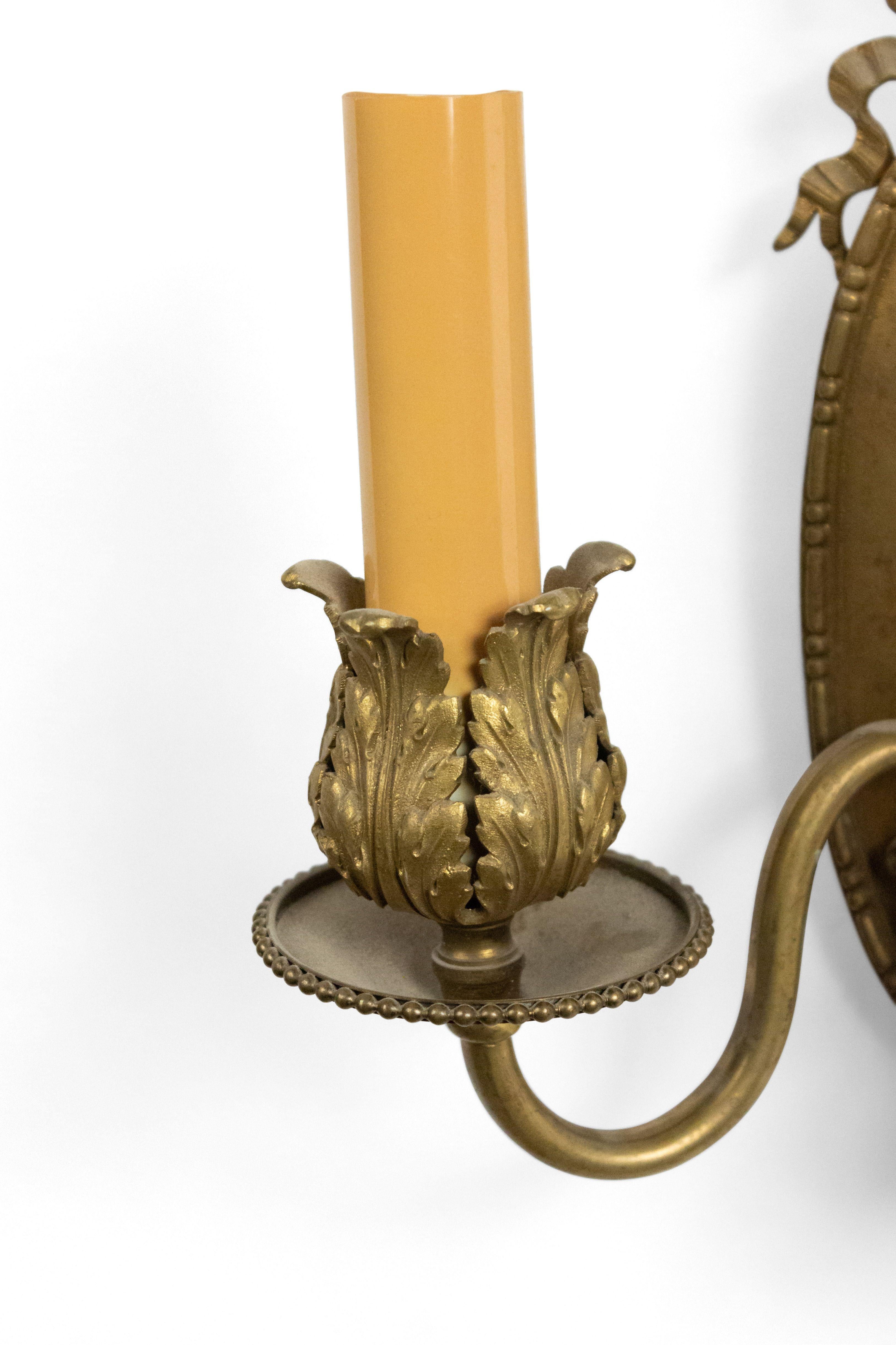 Pair of French Louis XVI style (20th century) bronze doré oval back 2-arm wall sconces with bow knot top.