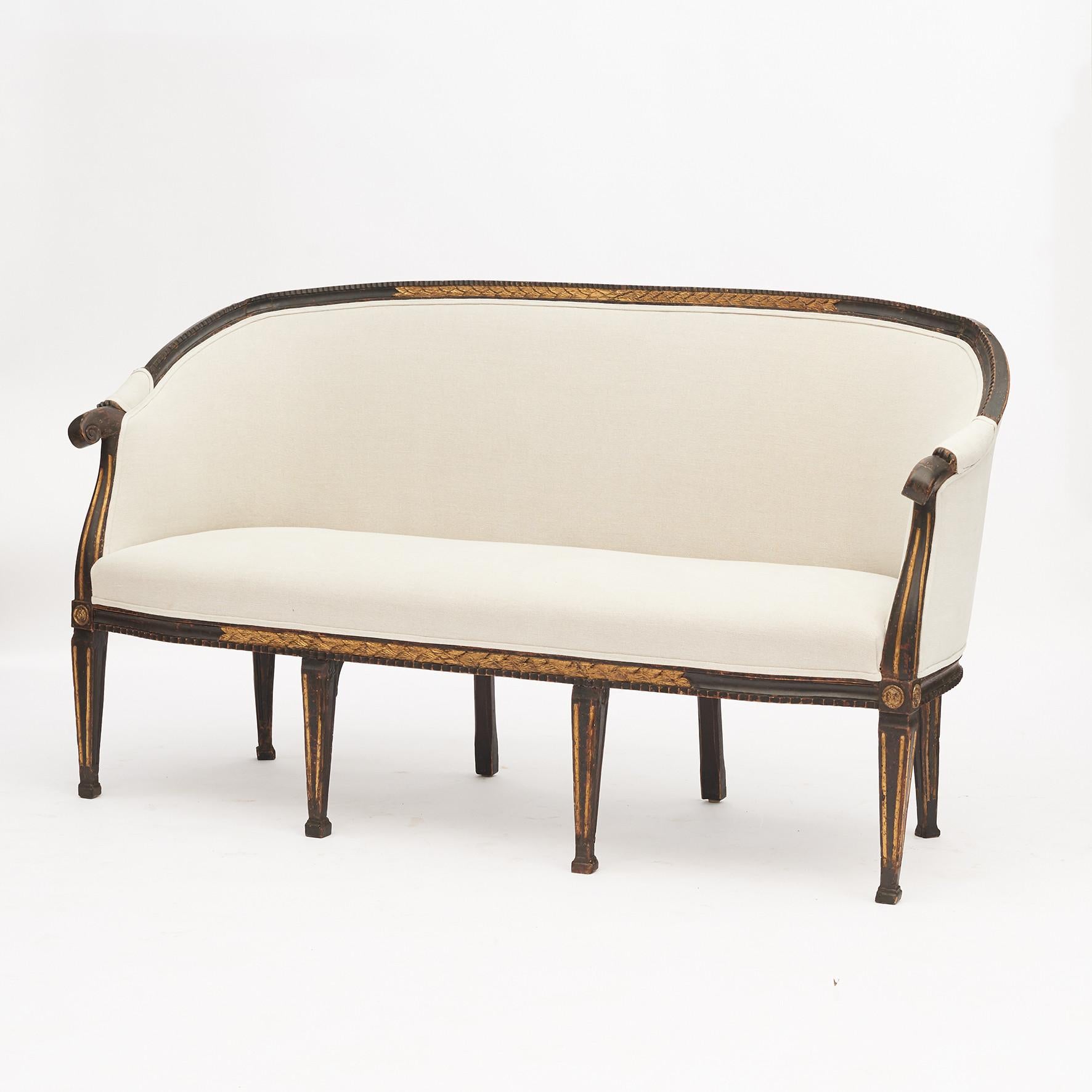 French Louis XVI canapé sofa.
Ebonized wood. Gilded foliage wood carvings. Supported on eight tapering and gilt fluted legs terminating on block feet.
France, 1780-1790.
Reupholstered in hemp fabric from 'Edmond Petit'.