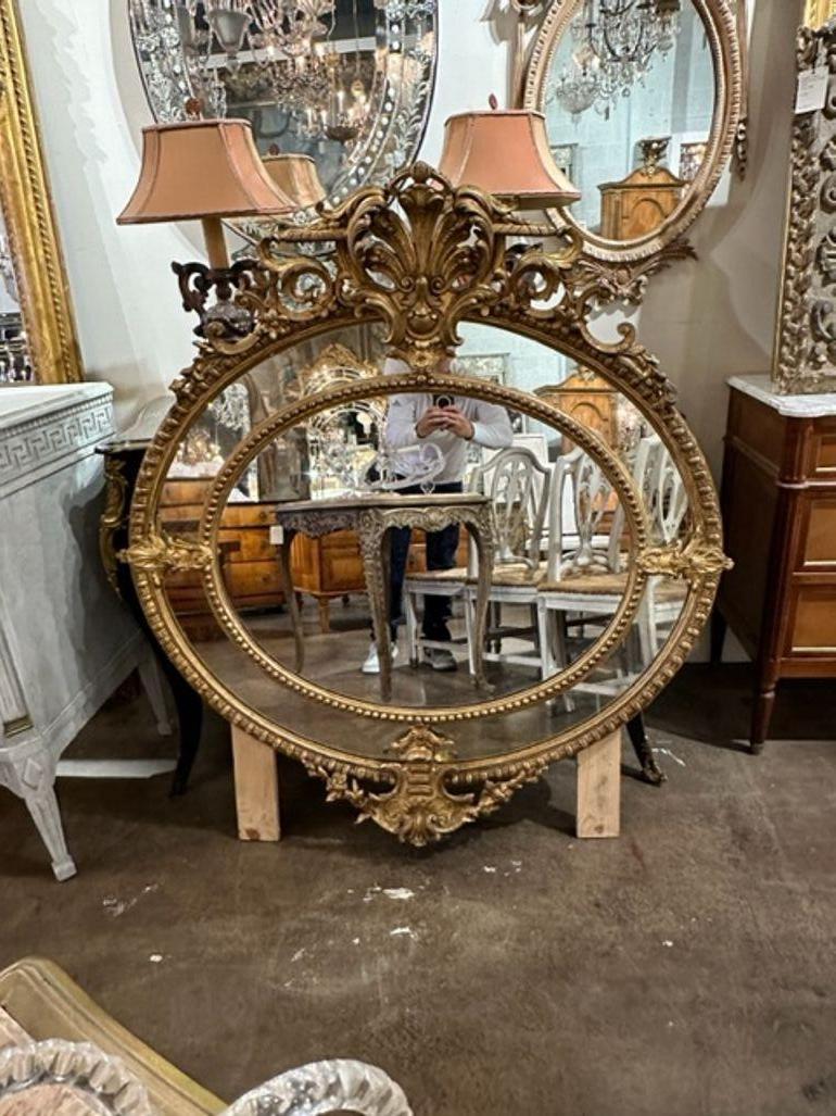 19th century Louis French XVI carved and giltwood oval mirror. Circa 1870. A fine addition to any home!