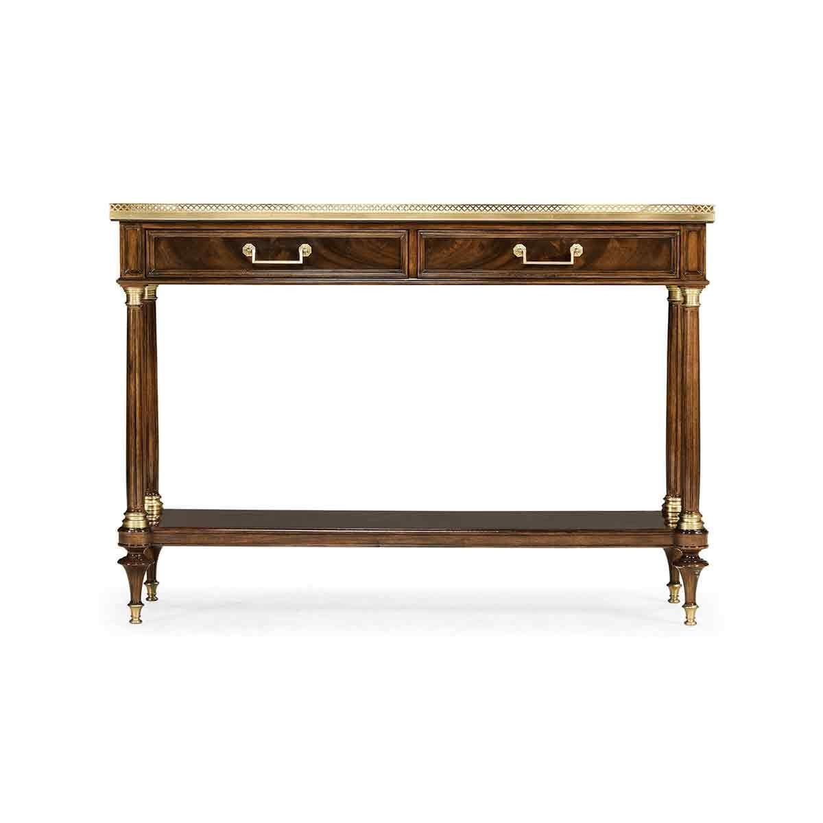 French Louis XVI mahogany console desserté with pierced brass gallery, two drawers, raised turned and fluted legs with shelf stretcher base and turned toupee feet on brass caps.

Dimensions: 53.87