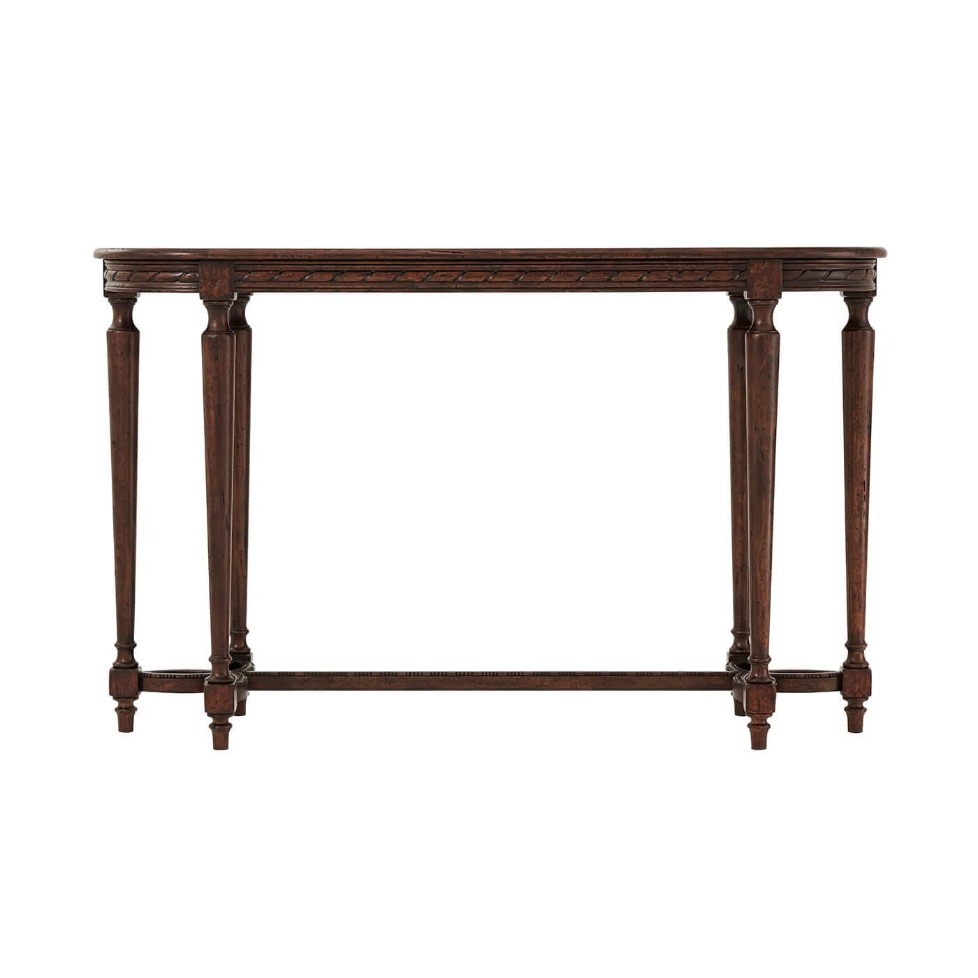 French Louis XVI style provincial carved console table with rustic oak veneers, the oval molded edge top with a carved ribbon apron with six turned and tapered legs joined by a trefoil carved and pieces stretcher base.

Dimensions: 54