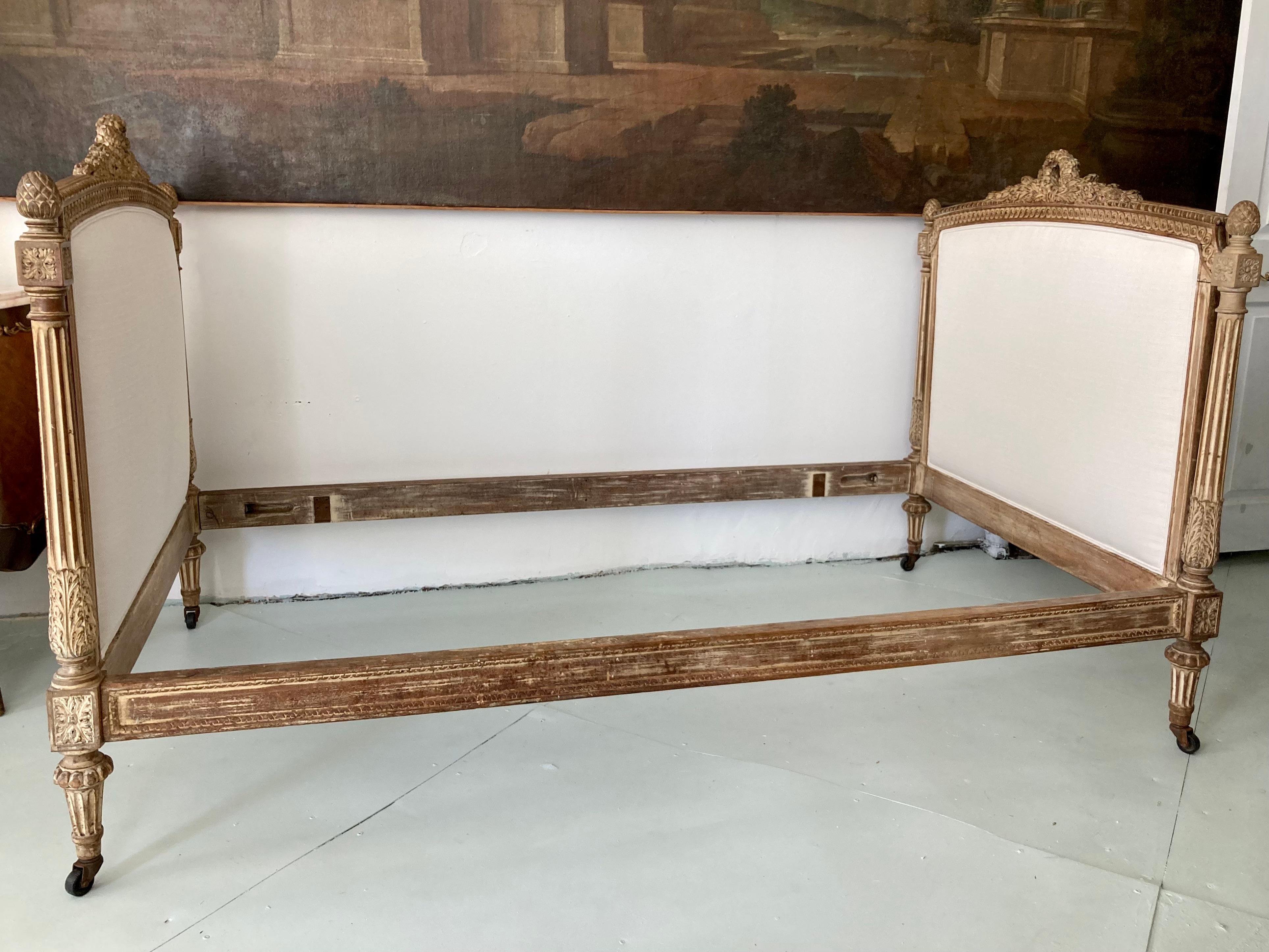 Fabulous French Louis XVI daybed. Original finish with new Todd Hase Upholstery that is upholstered in Todd Hase Textiles High Performance Off White. This frame accommodates a twin size mattress and spring. Add some French architecture to your