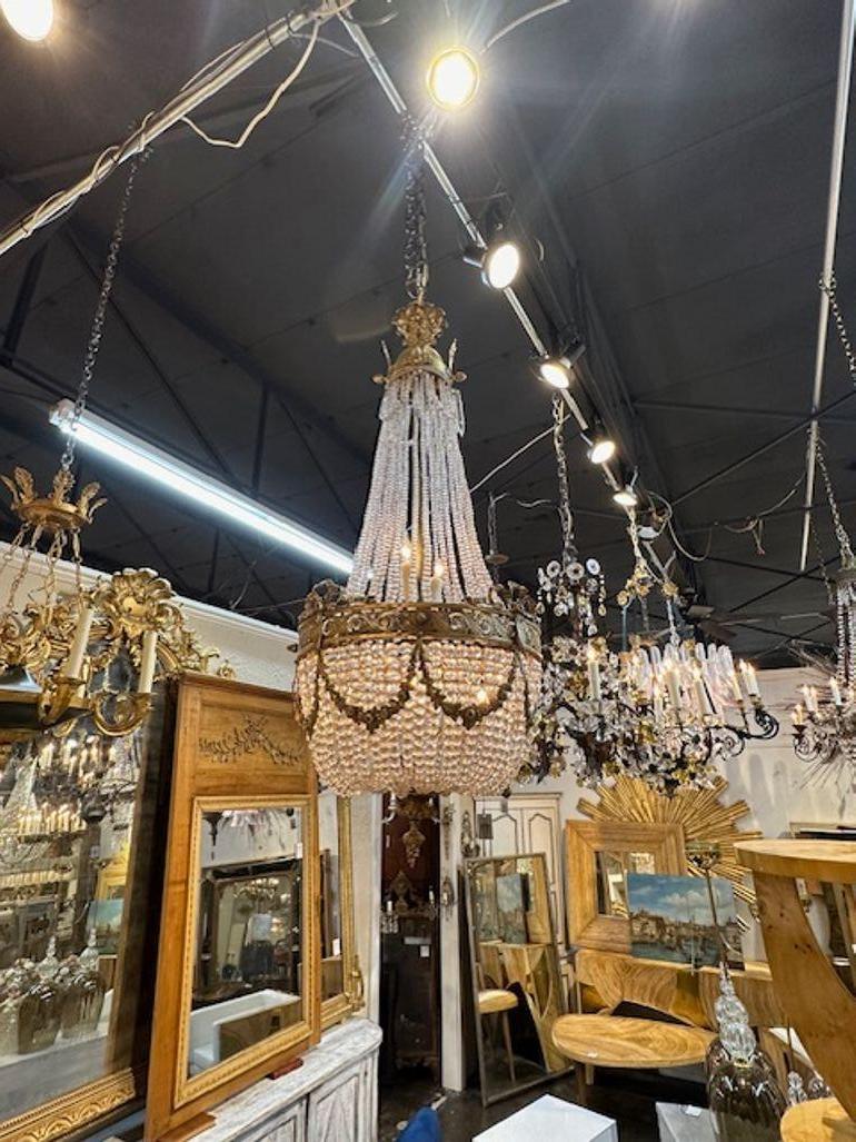 Late 19th century French Louis XVI design gilt bronze and crystal basket form chandelier. Circa 1890. The chandelier has been professionally rewired, comes with matching chain and canopy. It is ready to hang!