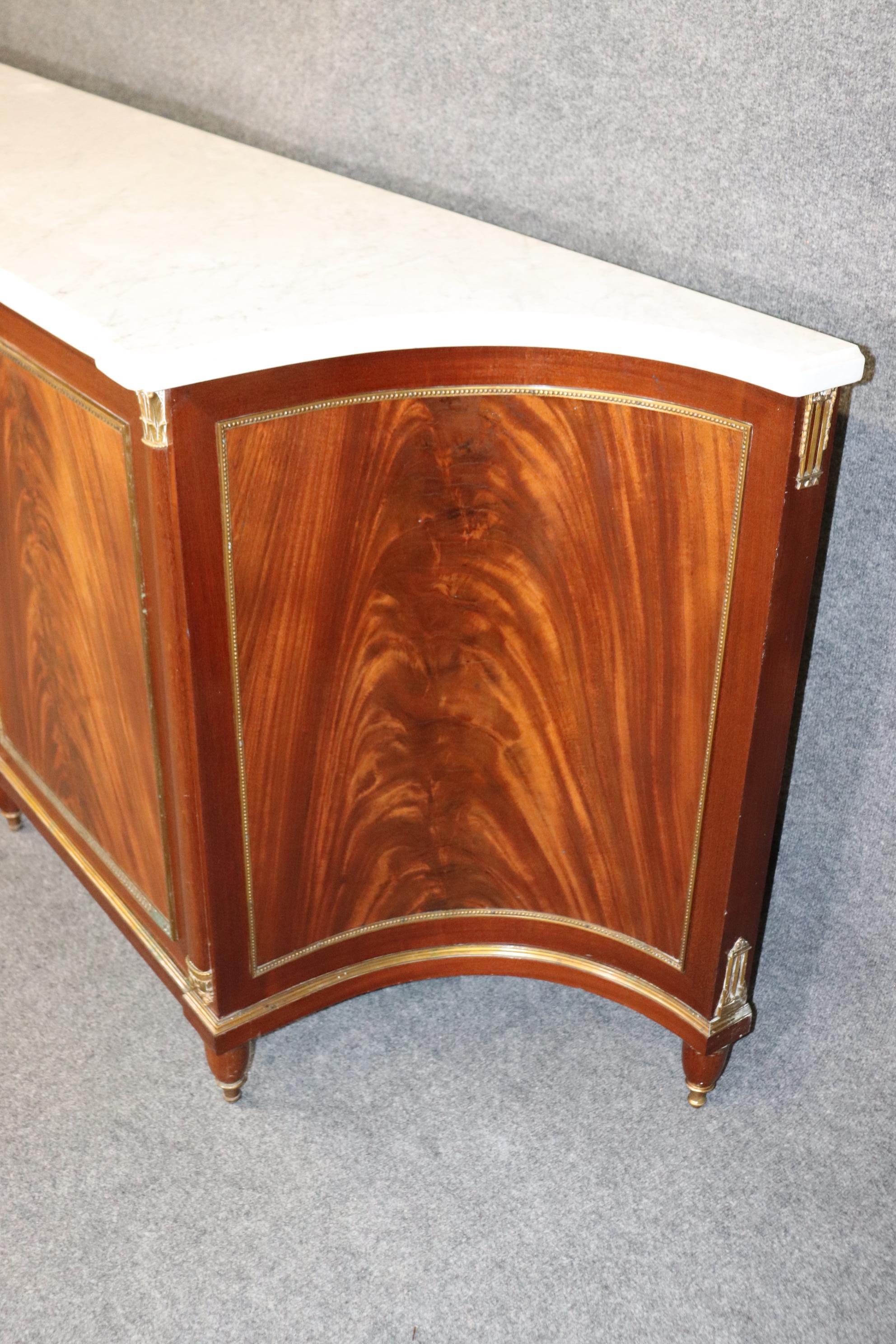 Dimensions- H: 35 1/2in W: 104in D: 21 1/4in 
This French Louis XVI Directoire Style Marble Top Sideboard Buffett By Maison Jansen is made of the highest quality and is bound to bring a sense of class and luxury into your home or place of choosing!