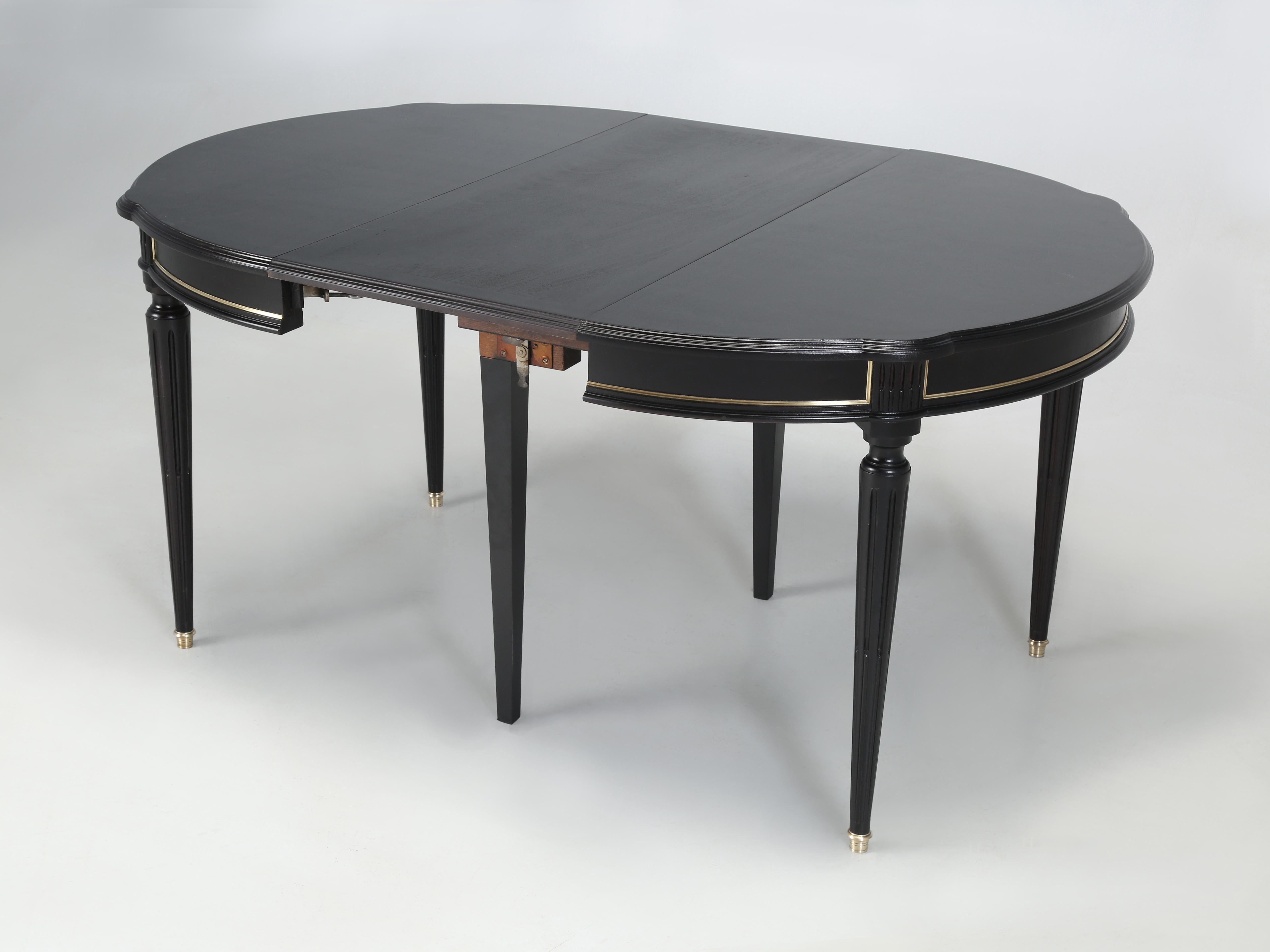 French Louis XVI Style Ebonized Mahogany Round Dining Table, with (3) large ebonized leaves fresh out of our Old Plank Restoration department. The finishing department completely hand-stripped our mahogany dining table to the bare wood and applied